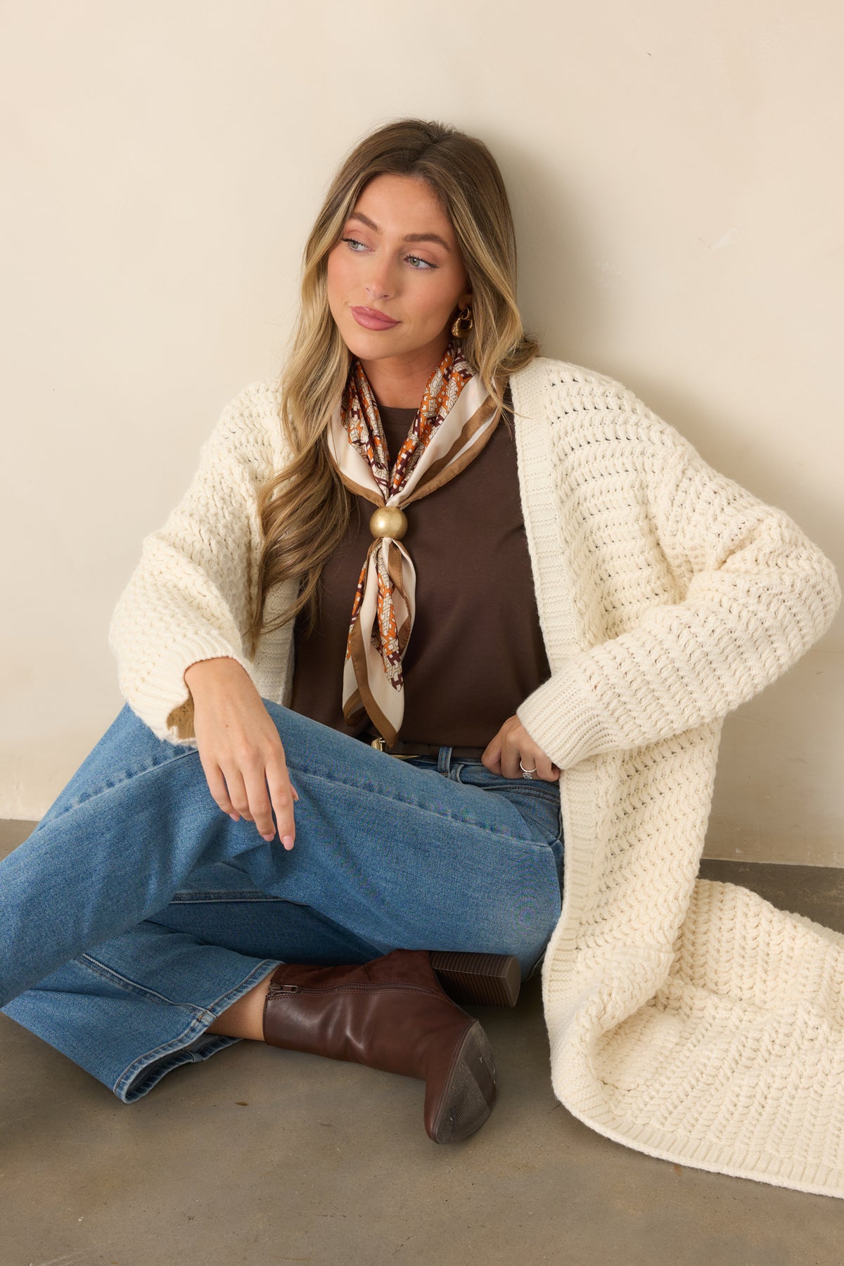 Textured cream knit cardigan featuring a front patch pocket and softly ribbed sleeve cuff.
