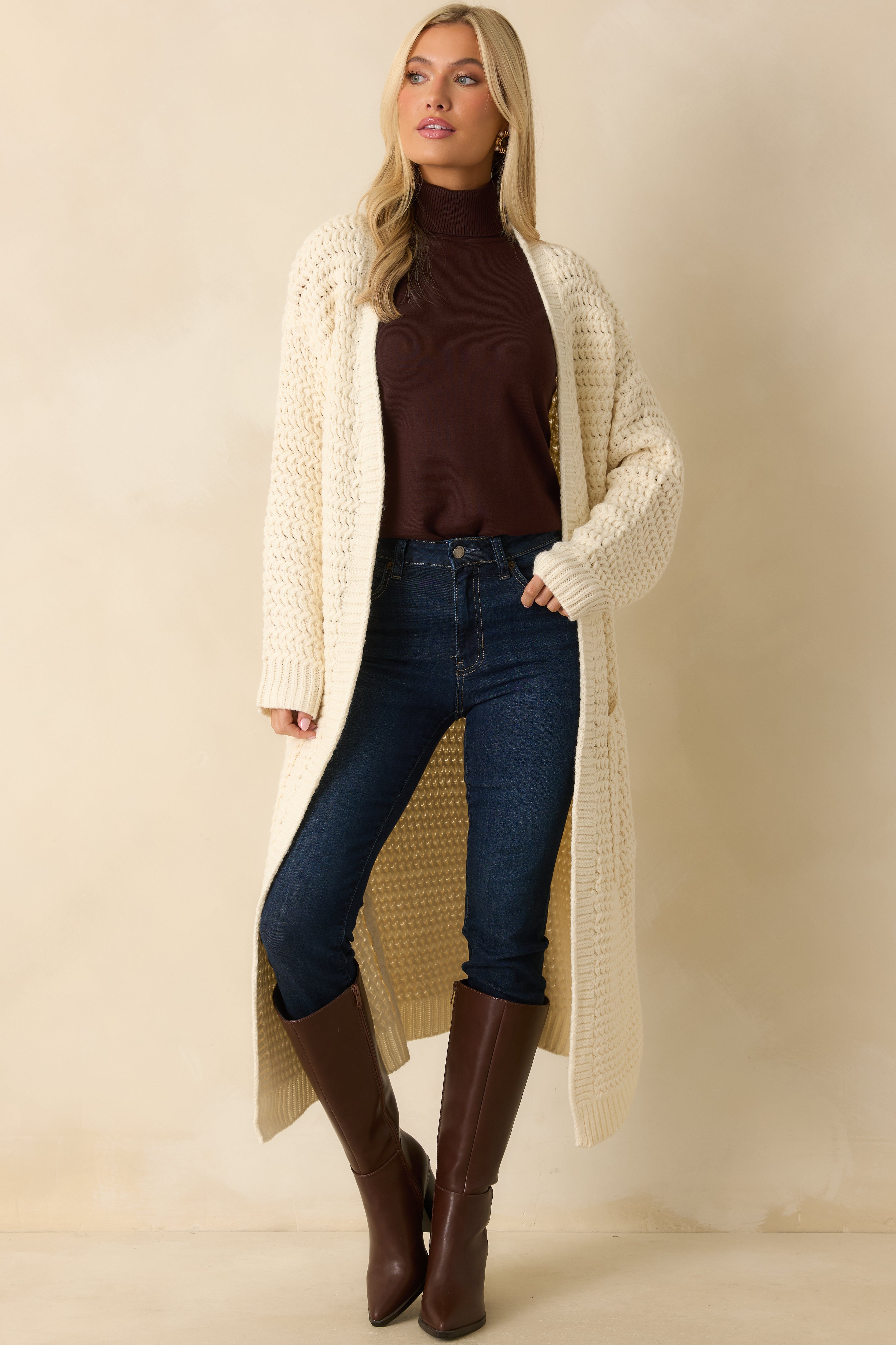 Cream knit duster cardigan highlighting the relaxed longline silhouette and cozy, soft texture.