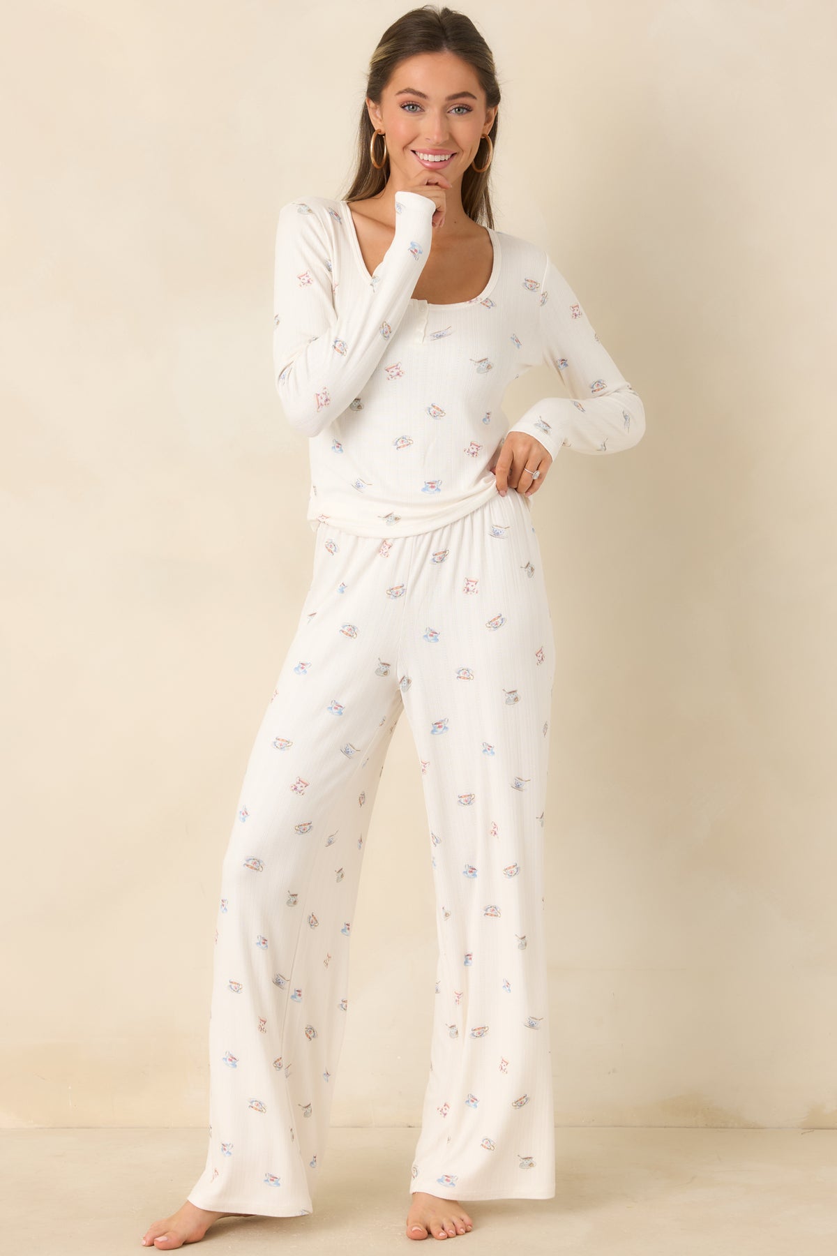 Cream printed lounge pants with a comfortable pull-on waist and draped wide legs.