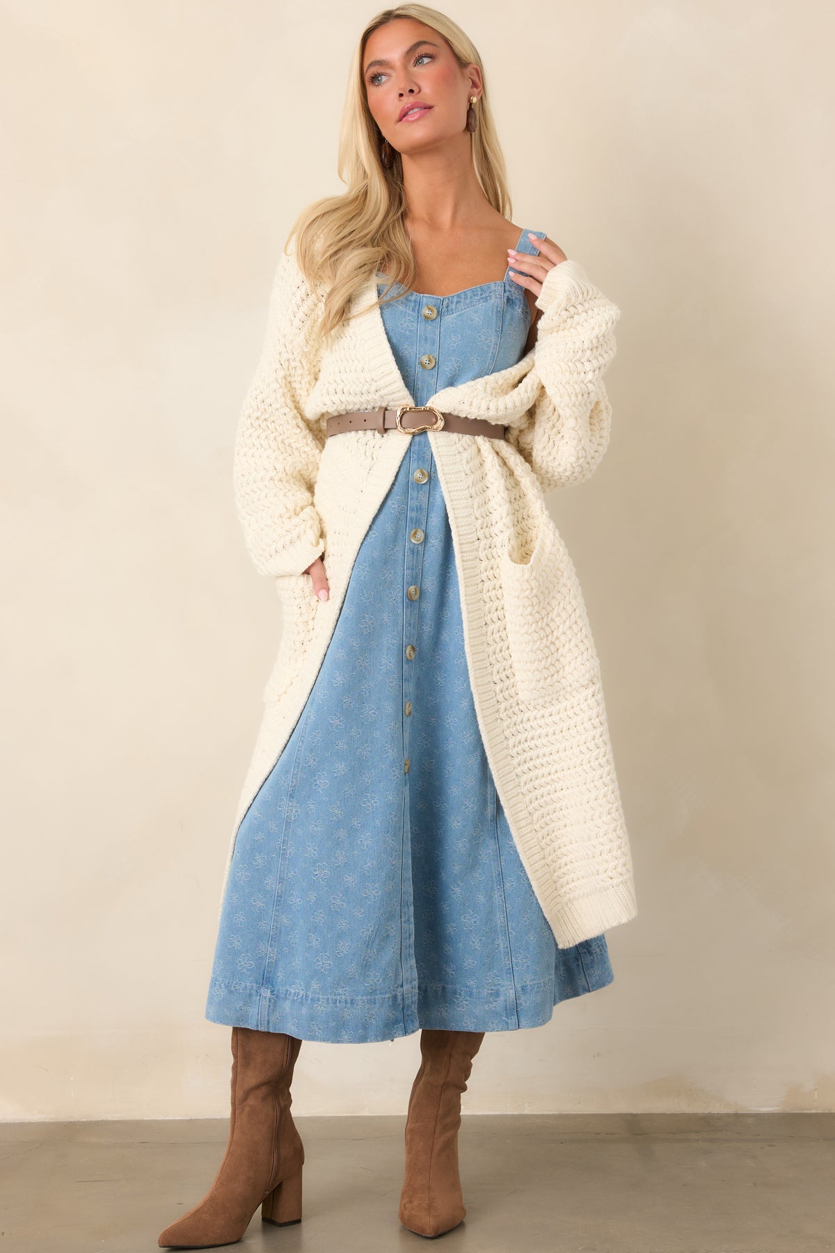Cream duster cardigan with a relaxed silhouette, open front, ribbed cuffs, and textured chunky knit construction.