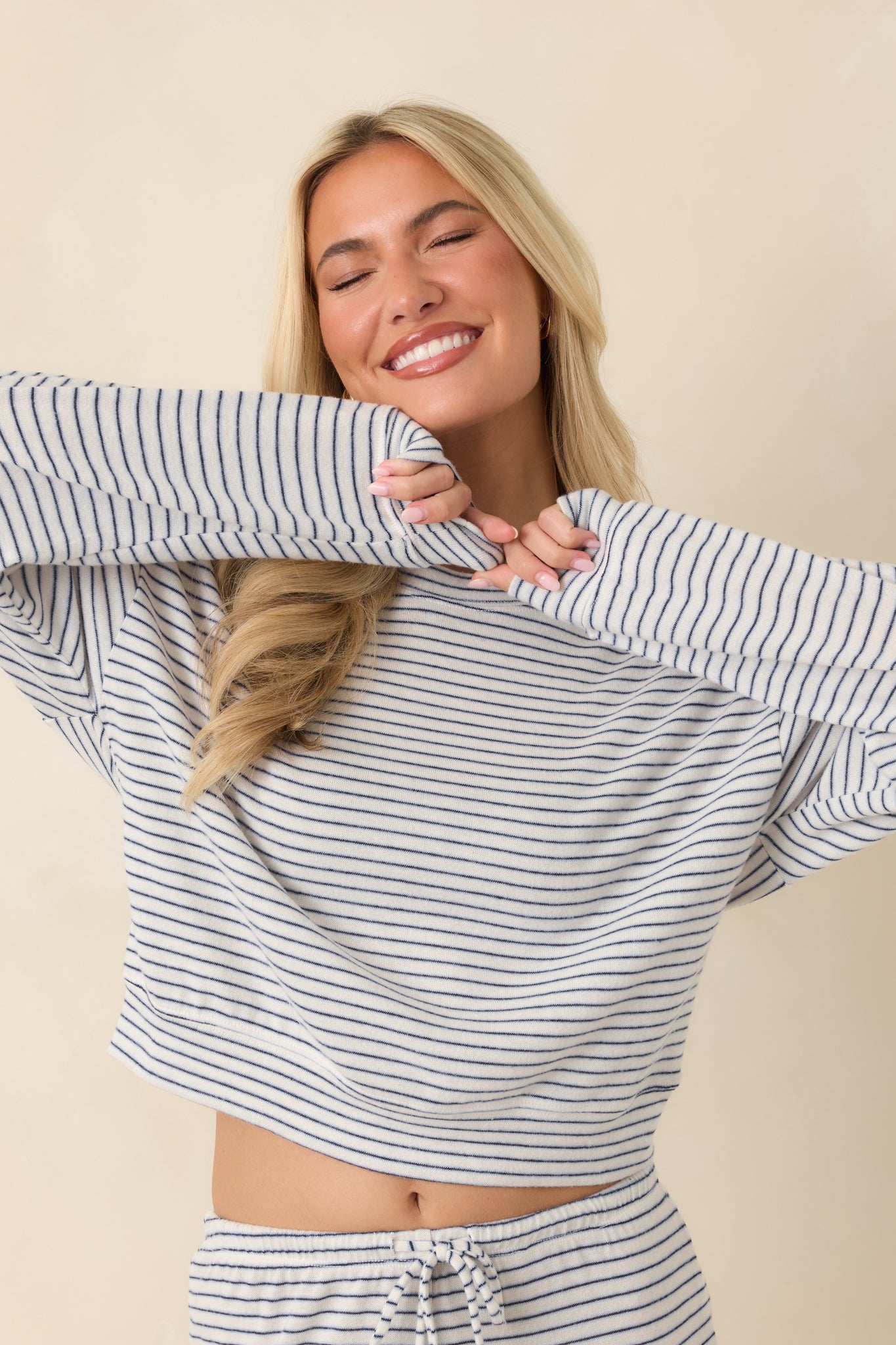 Detailed view of the crew neckline and soft brushed sweater knit texture on the striped pullover.