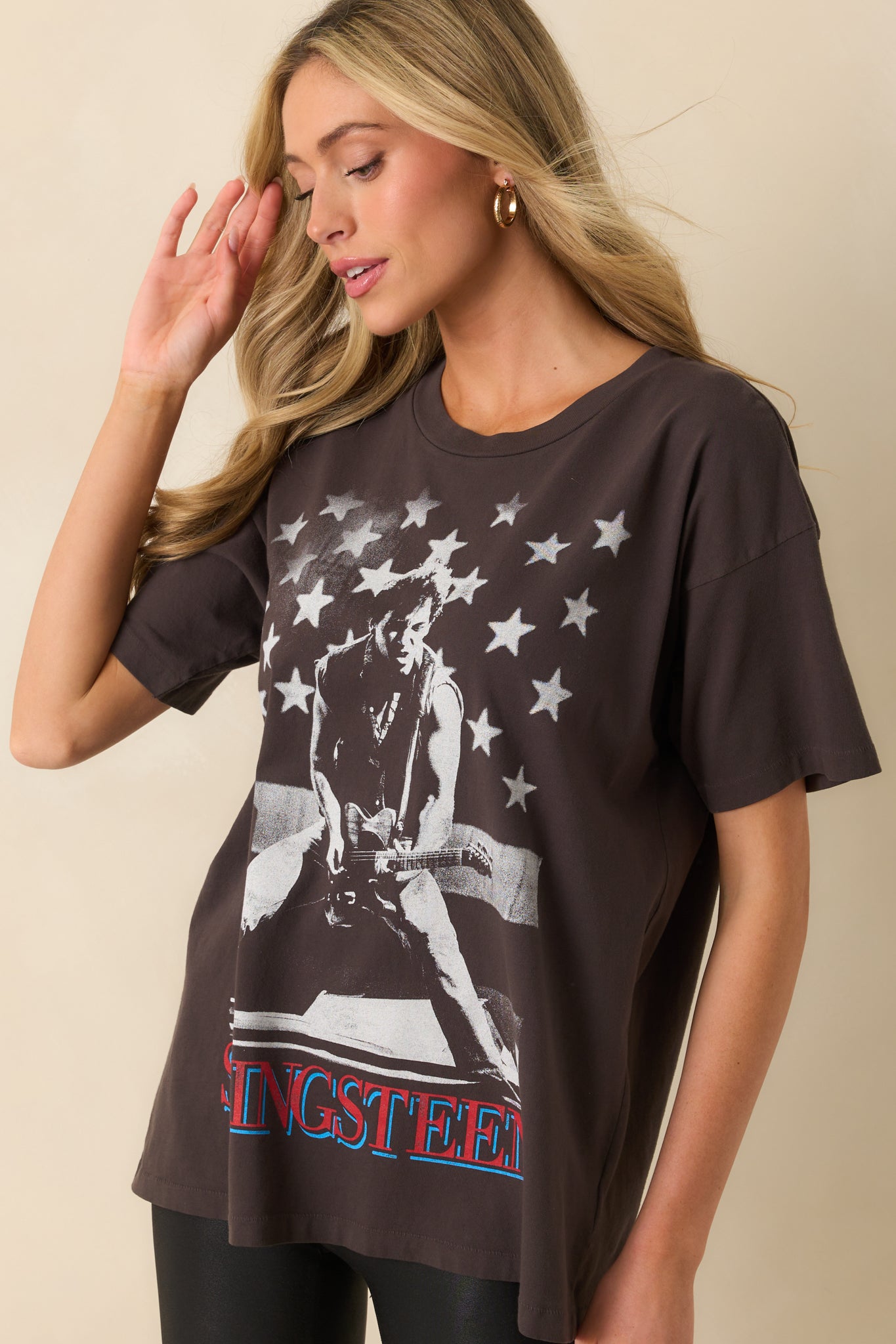 A cropped image highlighting the crew neckline and shoulder seam of the black oversized tee.