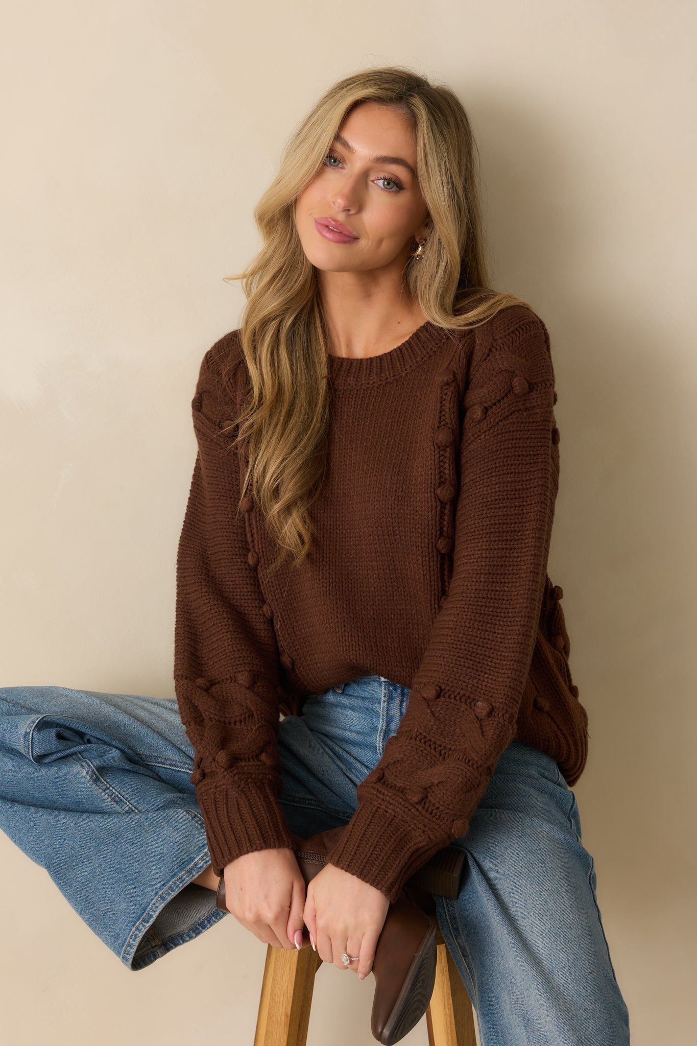 Crew neckline and upper knit detail of the chocolate brown sweater.