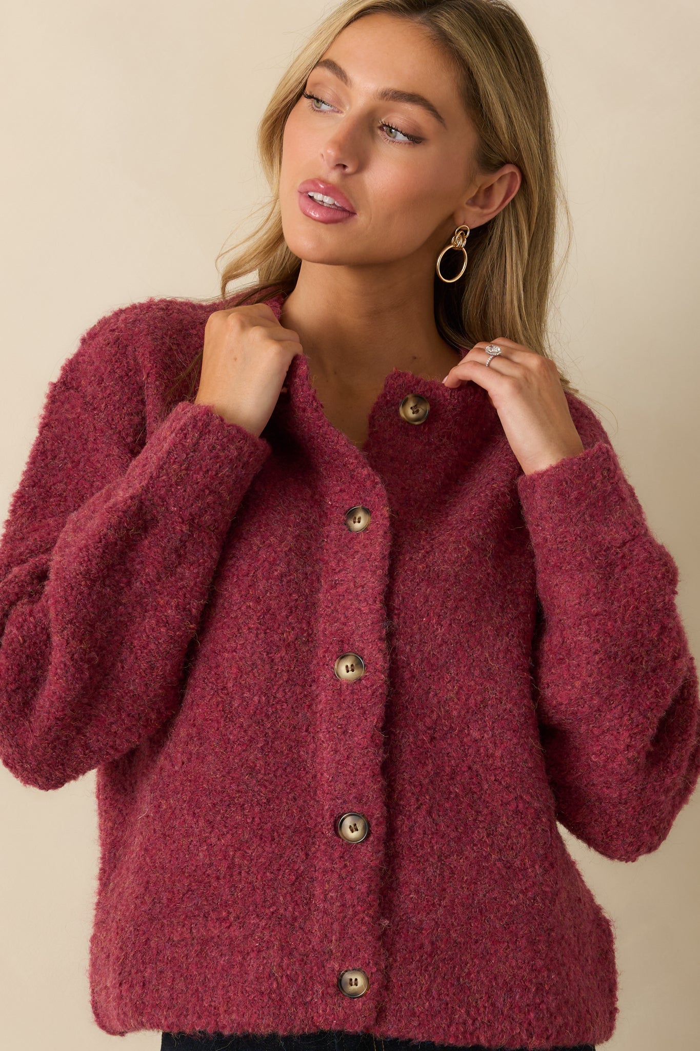 Close view of the crew neckline and upper knit texture, emphasizing the cozy boucle fabric.