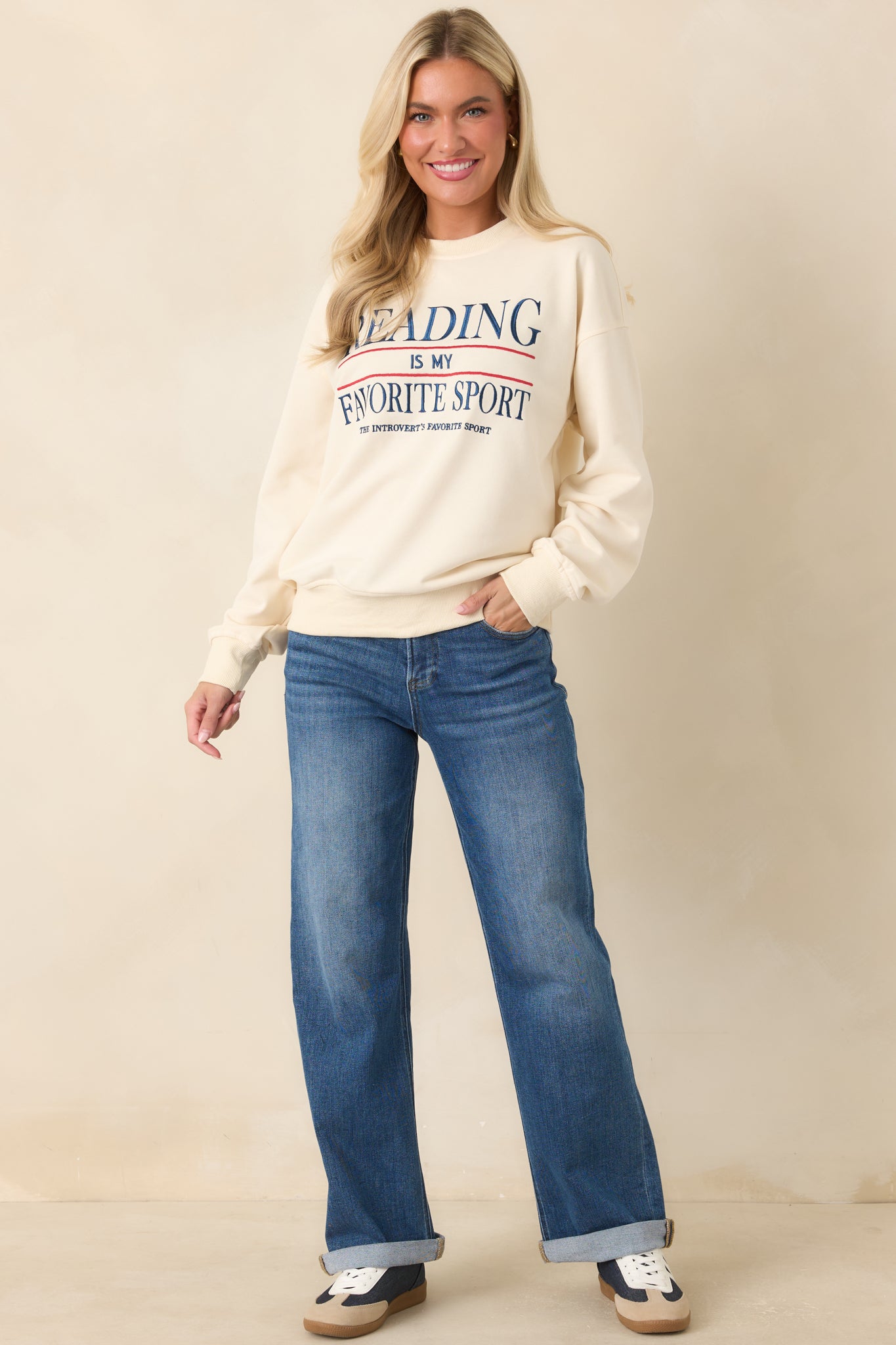 Crewneck sweatshirt with embroidered front text, long sleeves, and a relaxed silhouette in a soft ivory hue.