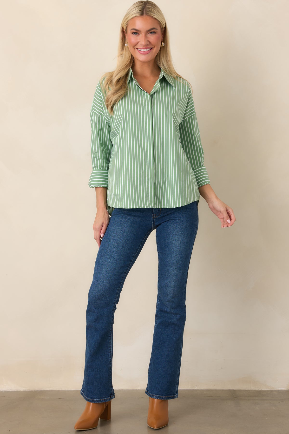 Classic collared shirt featuring a full button-front closure, relaxed drop shoulders, button cuffs, and a clean structured silhouette.