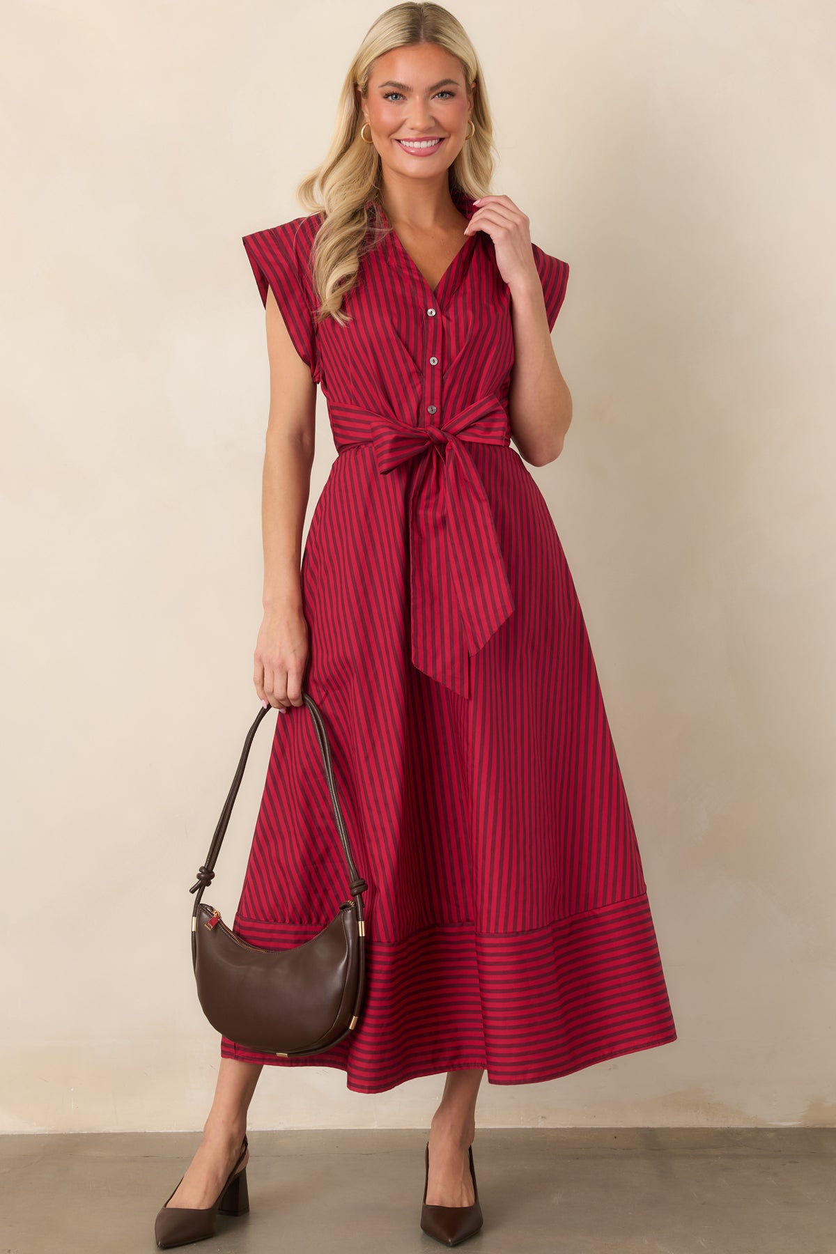 Crisp cotton striped midi dress featuring a collared neckline, partial button-front placket, cap sleeves, and statement waist ties.