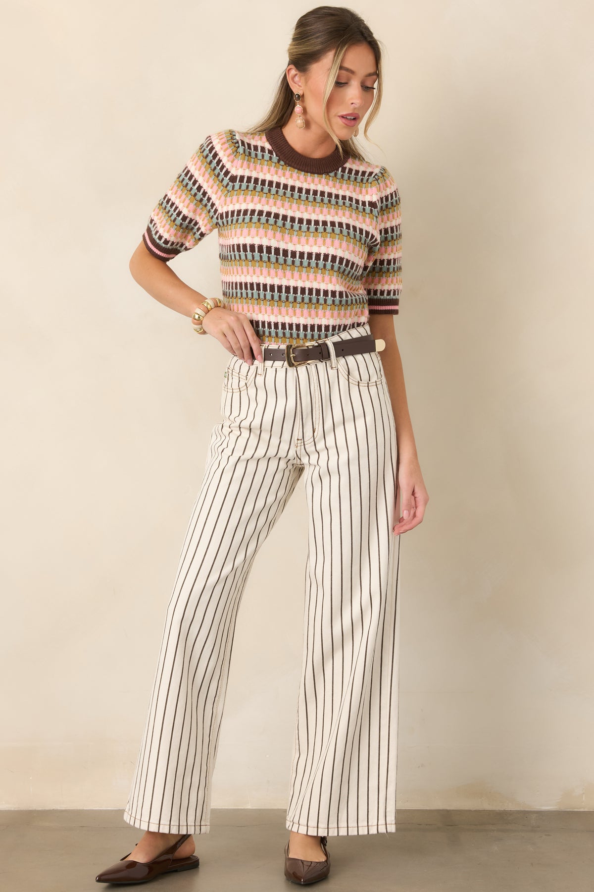 Crisp ivory wide-leg denim pants with slender brown pinstripes, a flattering high-rise waist, classic five-pocket styling, and a relaxed full-length silhouette.