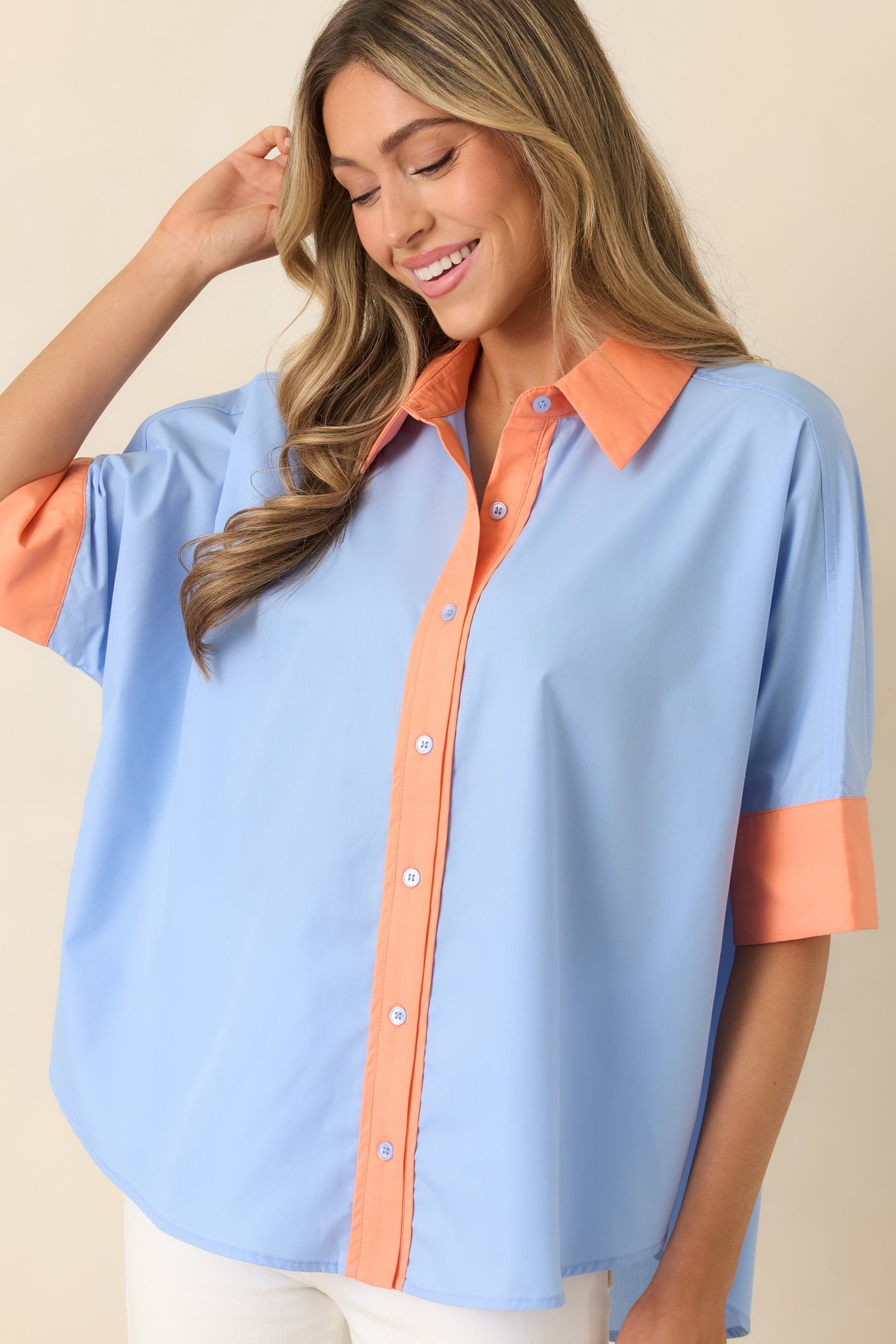 Crisp woven top, featuring detailed stitching and bold contrast accents along the front.