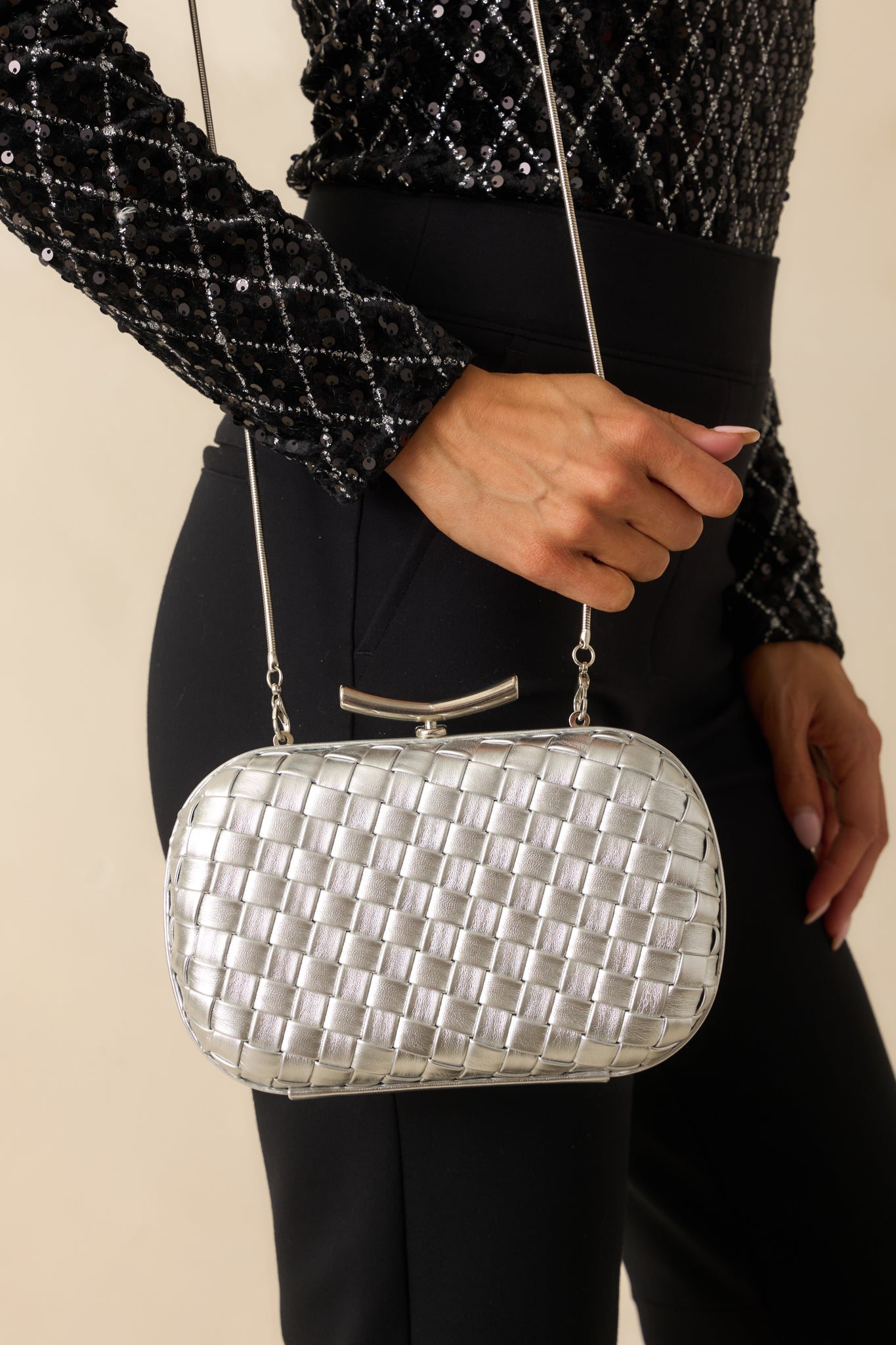 Crop highlighting the rounded corners and sleek structured body with optional crossbody chain.