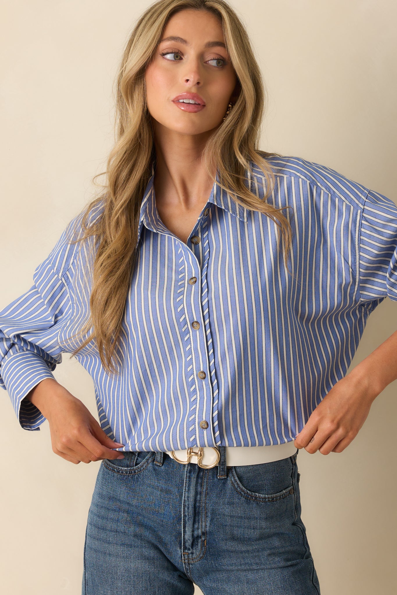 Crop showing scoop bottom hem and stripe alignment across the torso.