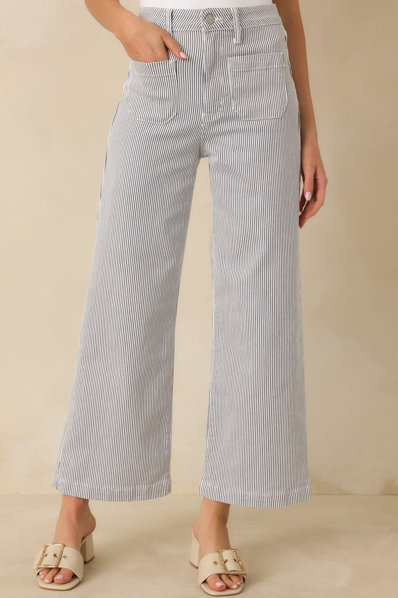 Cropped perspective showing the wide leg silhouette and vertical stripe detailing along the front of the jeans.