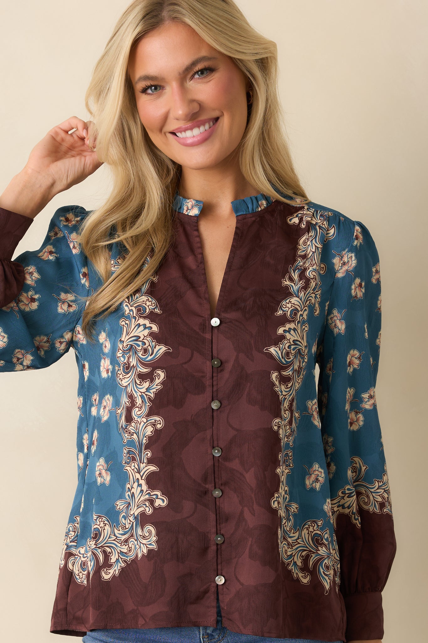 A cropped angle showing the button cuffs and sleeve volume with floral print accents.