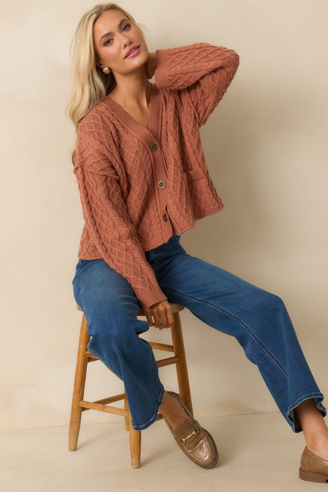 A cropped angled front view emphasizing the cable knit texture and relaxed silhouette.