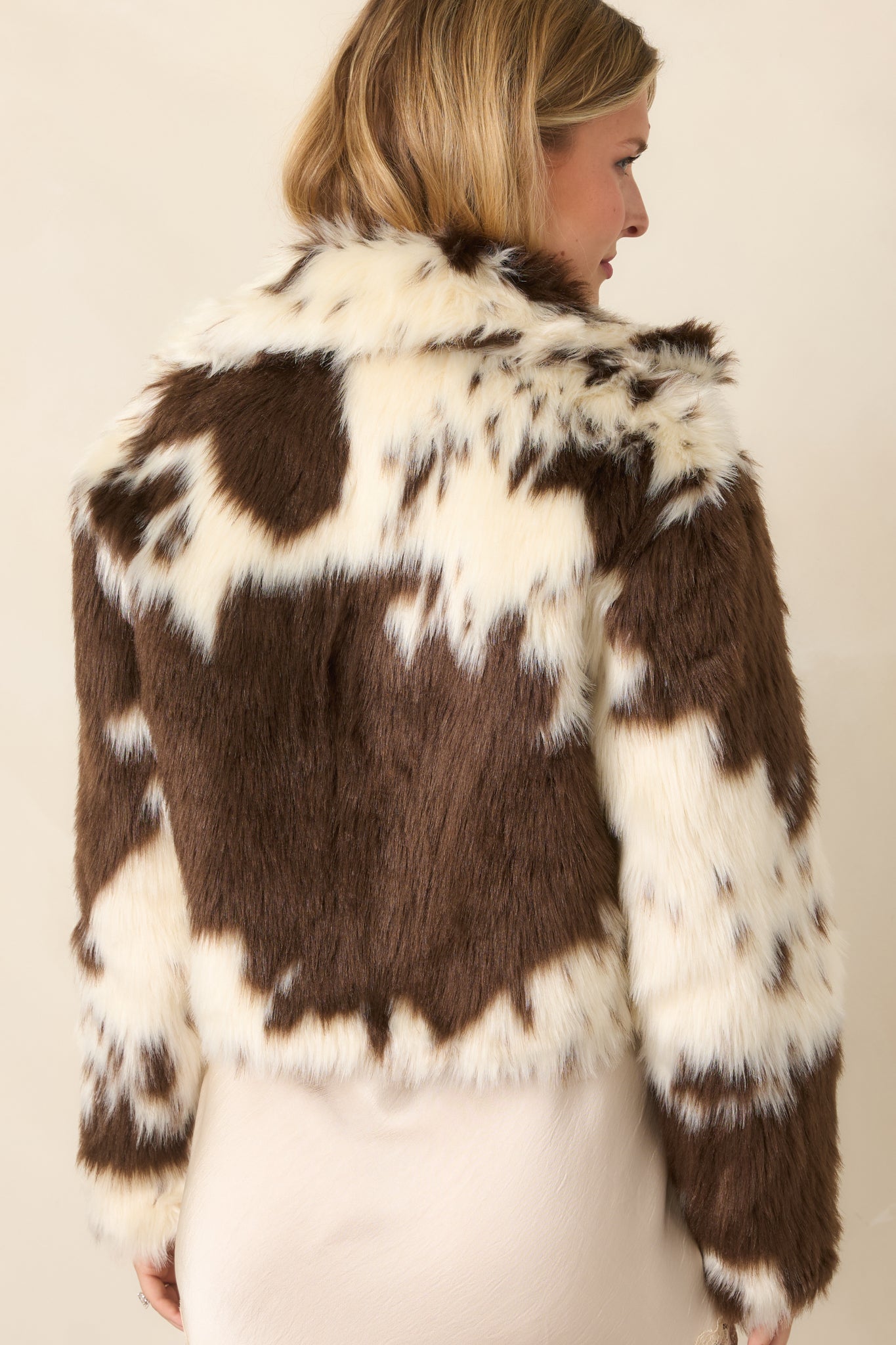 Rear view of the cropped bomber jacket highlighting its clean, relaxed silhouette and full lining.
