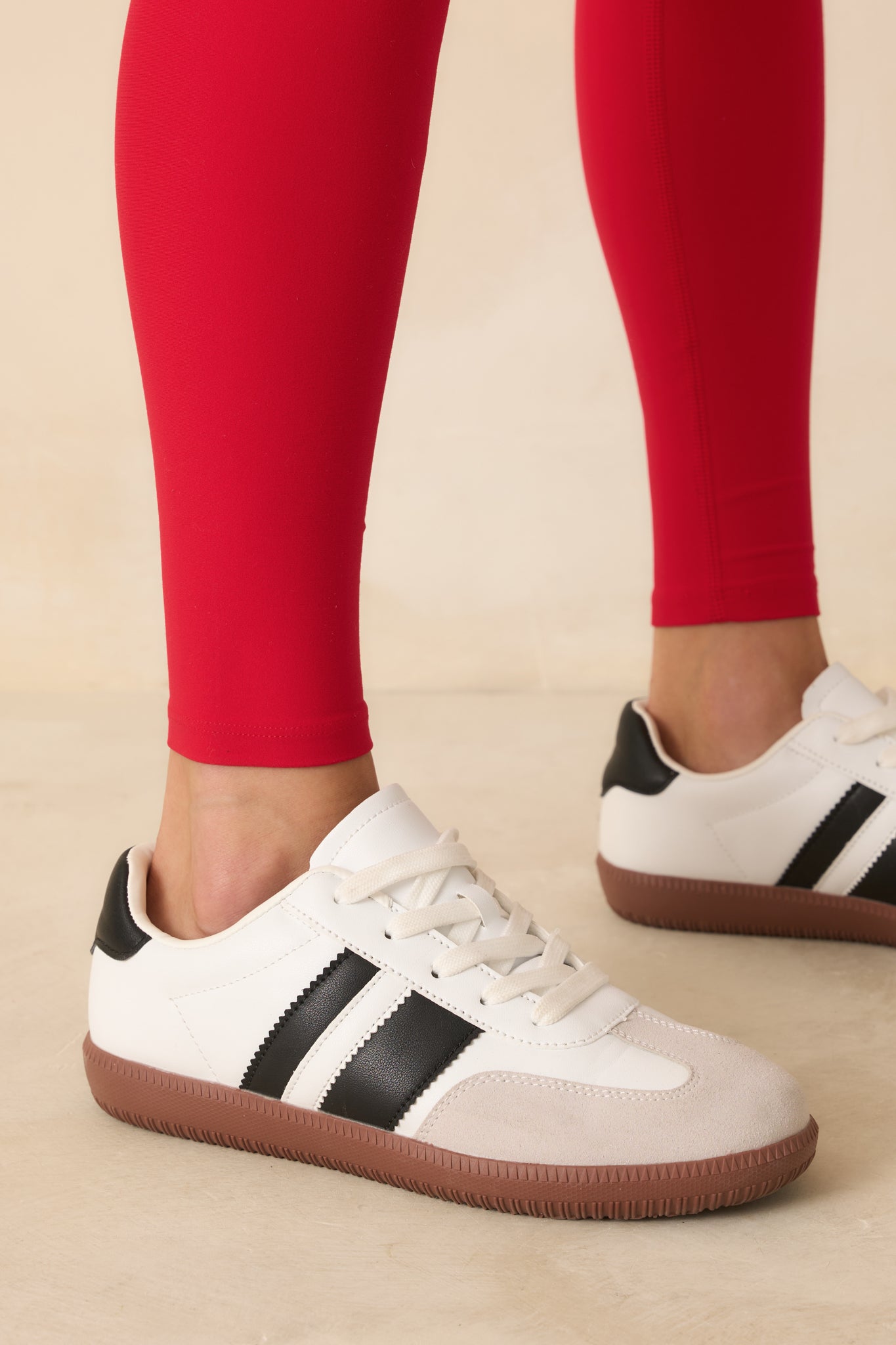 Cropped close view of the black contrast stripe and visible transitions between synthetic leather and suede textures.