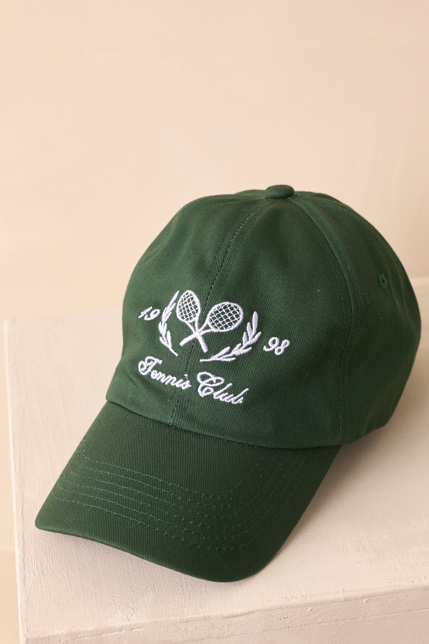 A close-up cropped angle highlighting the curved brim and six-panel crown with stitched eyelets.