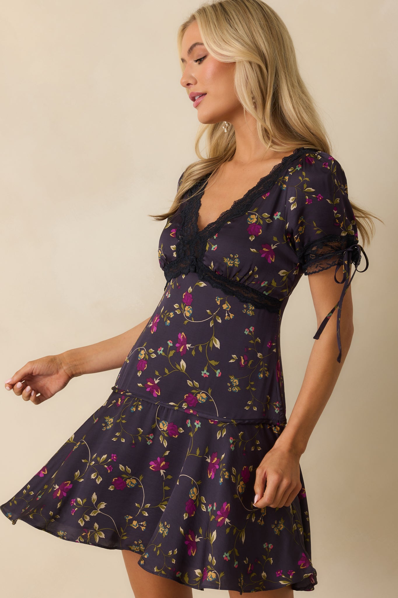 A cropped close-up of the skirt section, showing the drop-waist seam and flow of the flared hemline.