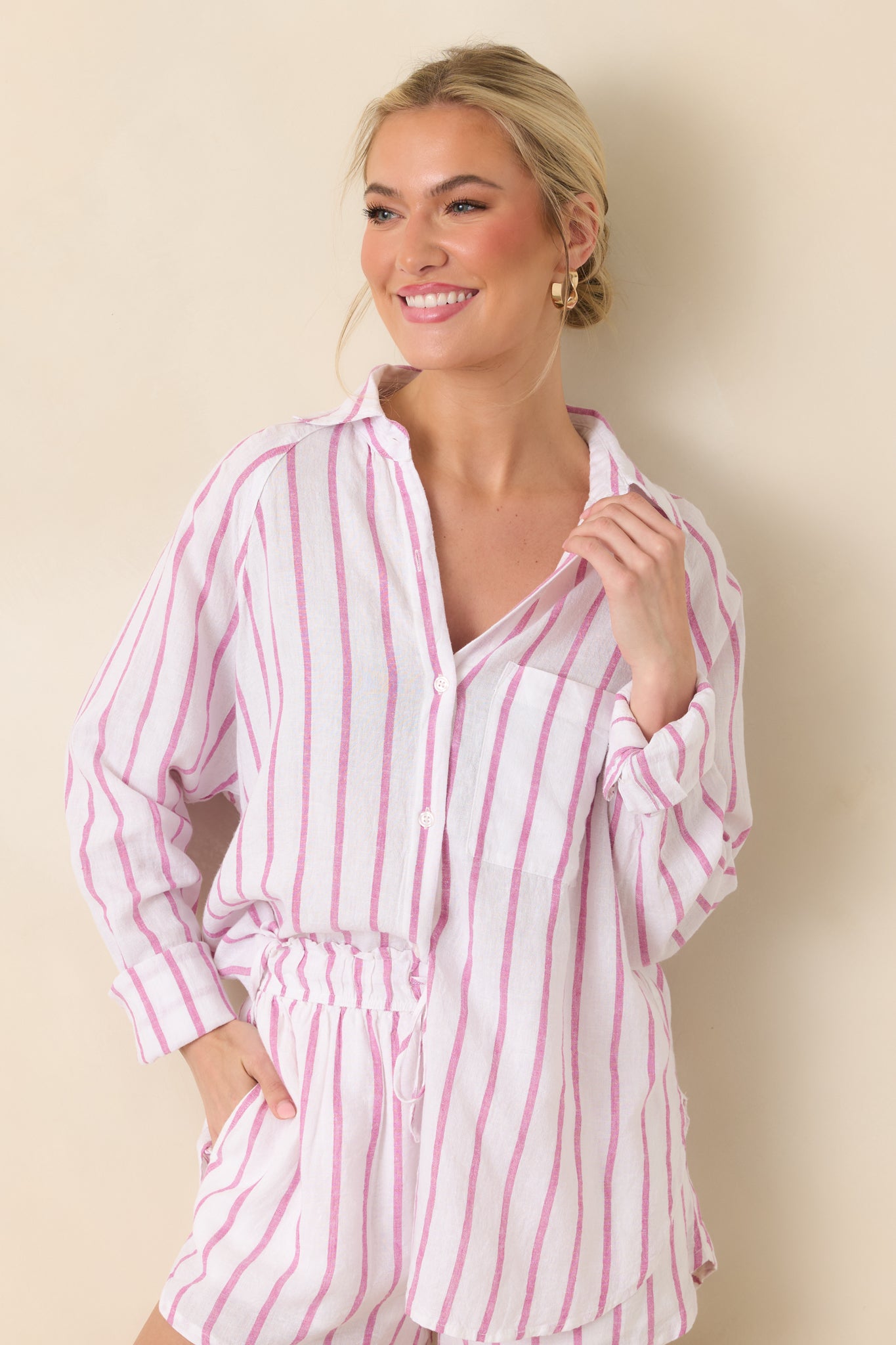 Cropped view highlighting the collared neckline and soft vertical rose pink stripes.