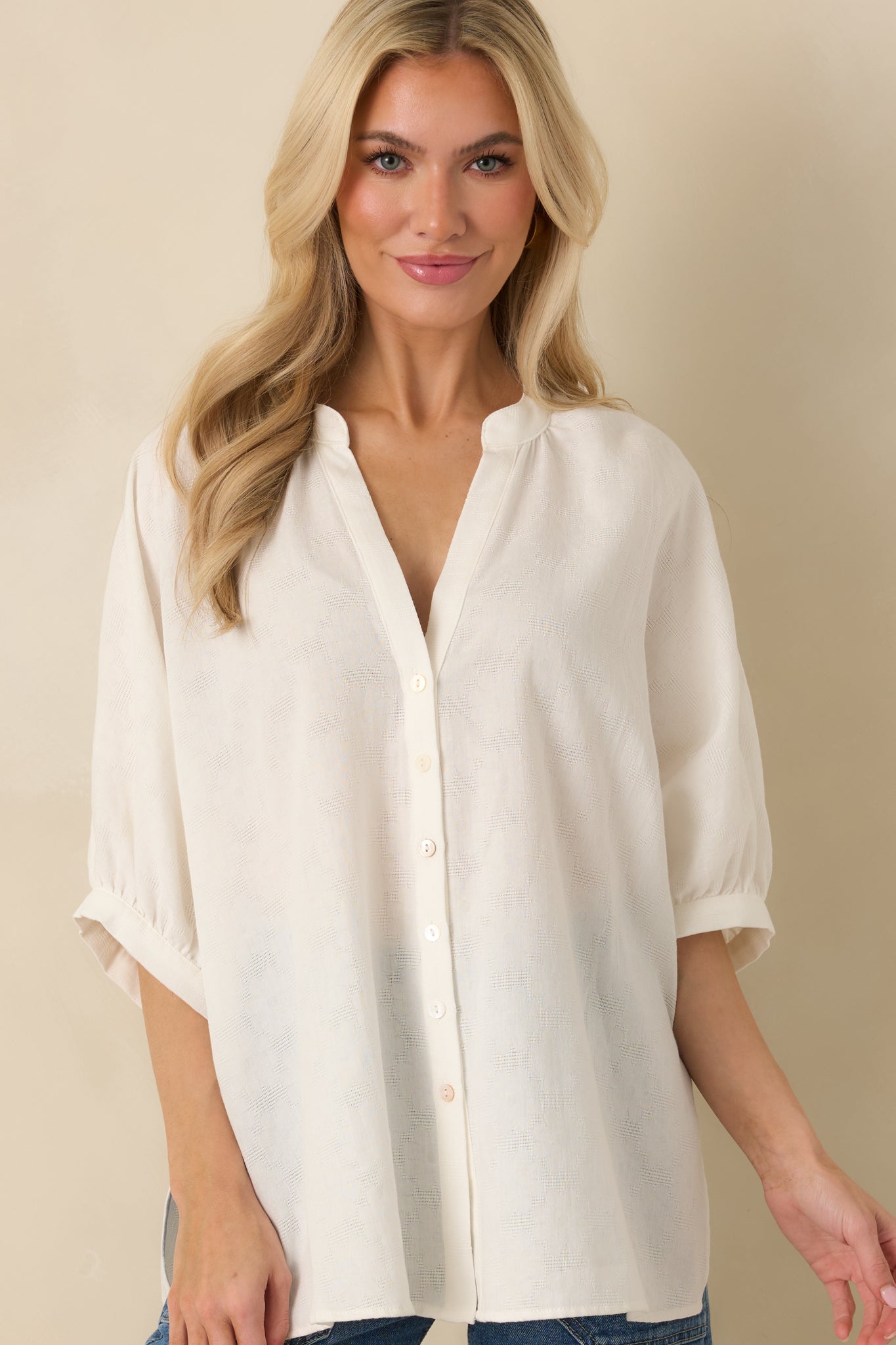 Cropped detail highlighting softly gathered 3/4 sleeves with elastic cuffs.