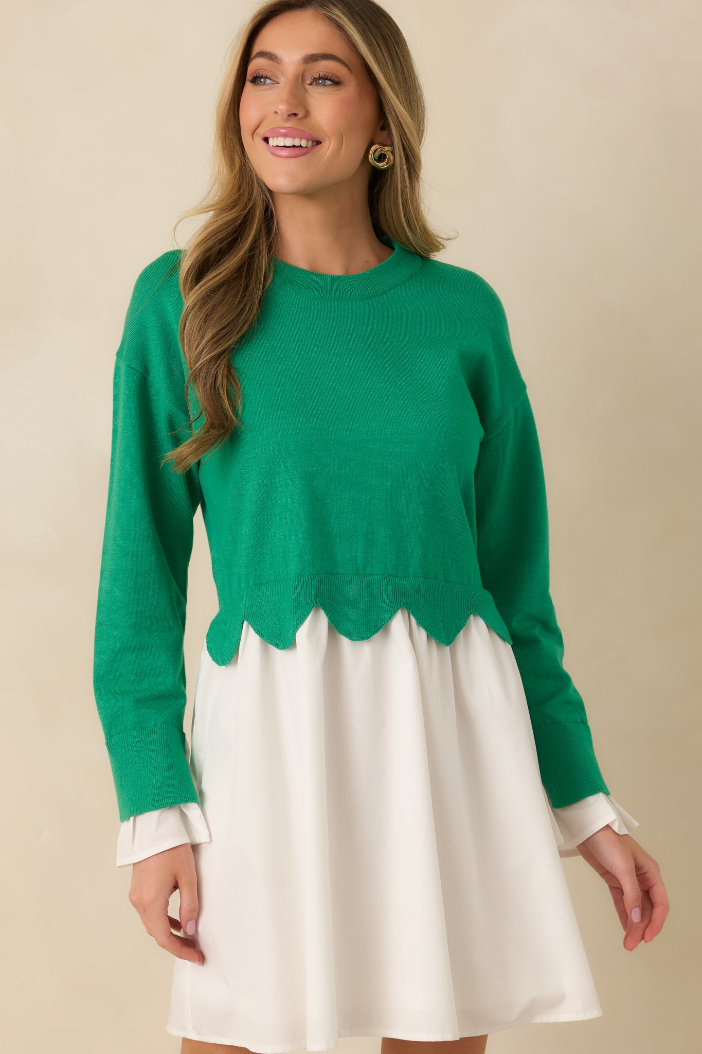 Cropped detail of the mini dress highlighting the contrast between the soft knit bodice and the flowy woven skirt.