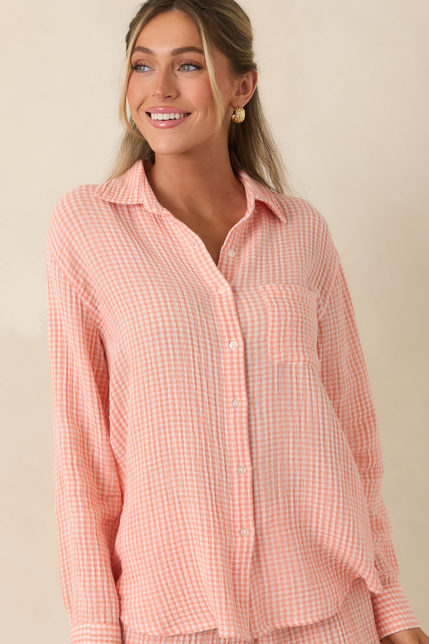 Close cropped detail of the chest pocket and soft cotton fabric on the gingham top