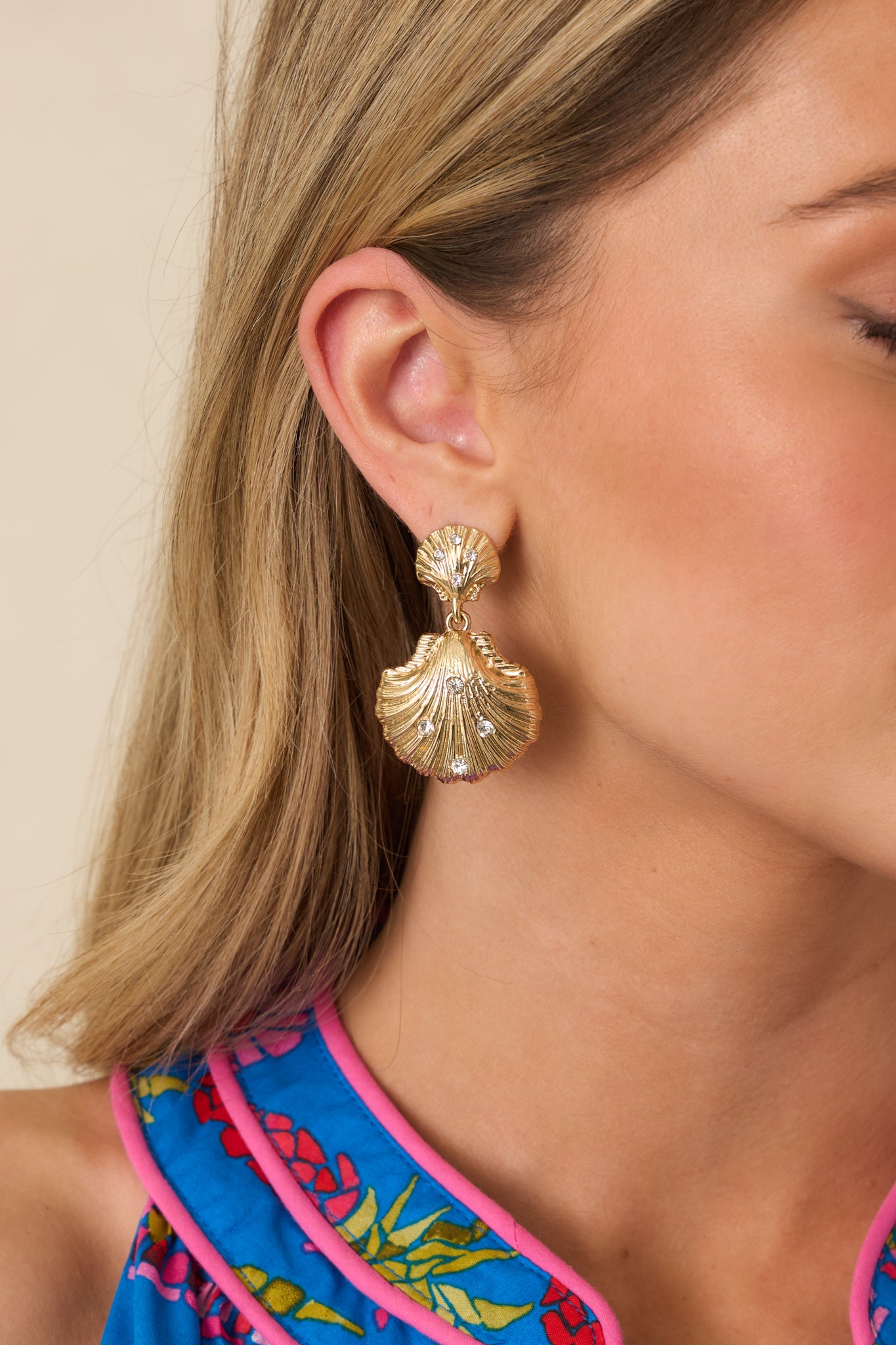 Detailed cropped look at earring showing scallop shapes and rhinestone embellishments.