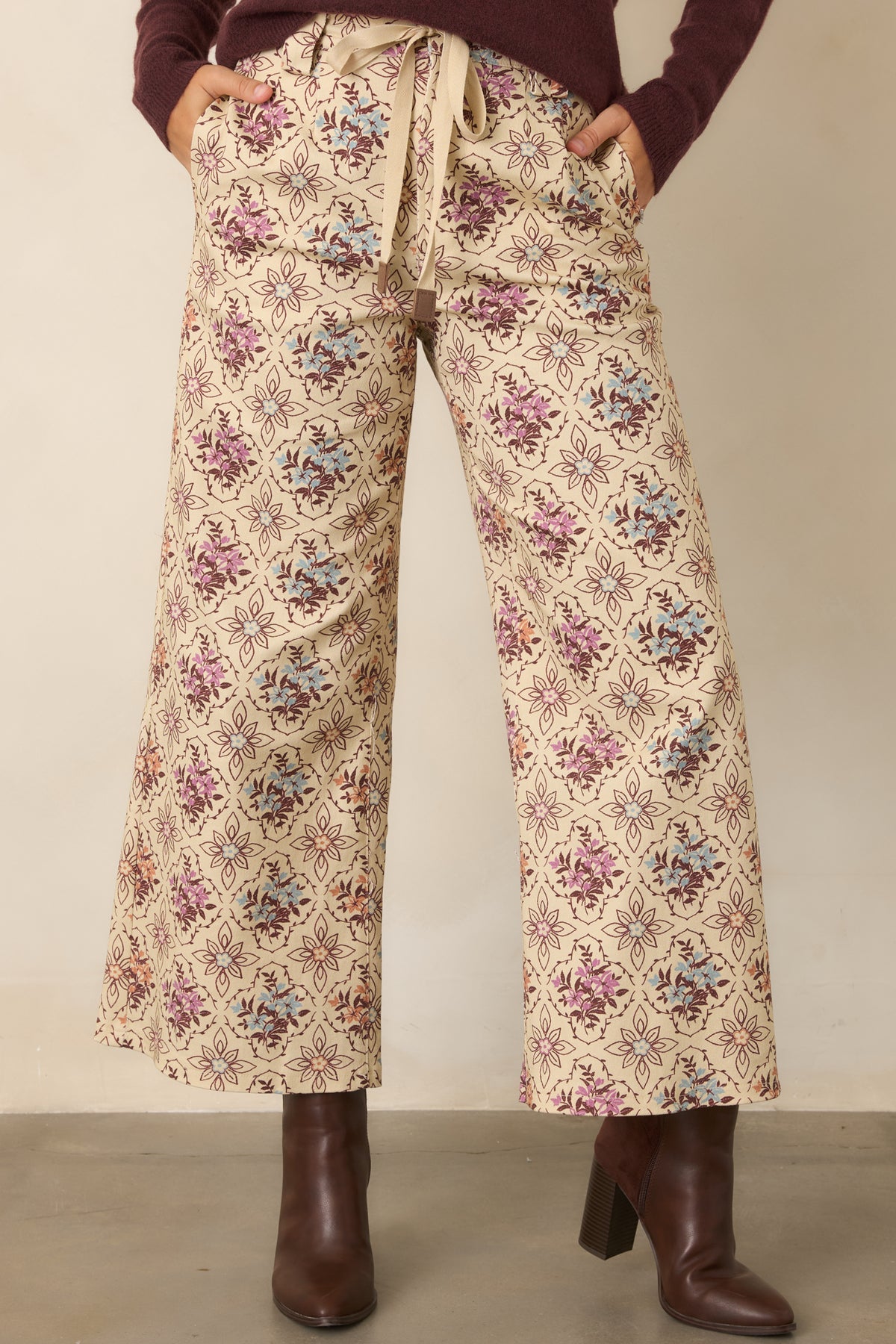 Cropped ecru pants showcasing the softly vintage floral print and relaxed wide-leg shape.