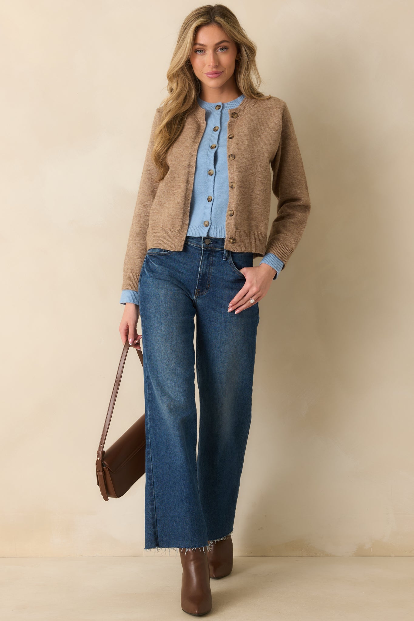 Cropped image focusing on the soft knit texture and layered design along the front of the cardigan.