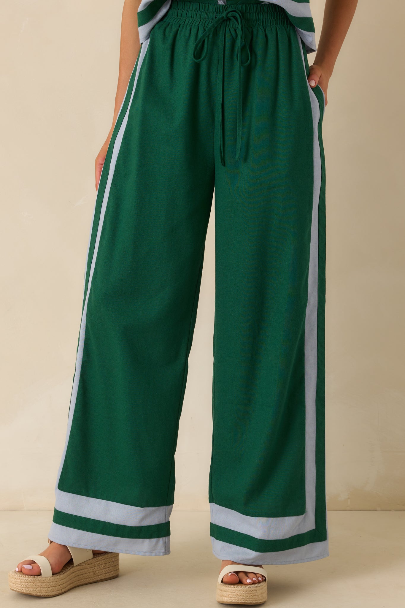 Cropped front detail focusing on the waistband, drawstring tie, and contrast trim at the pockets.