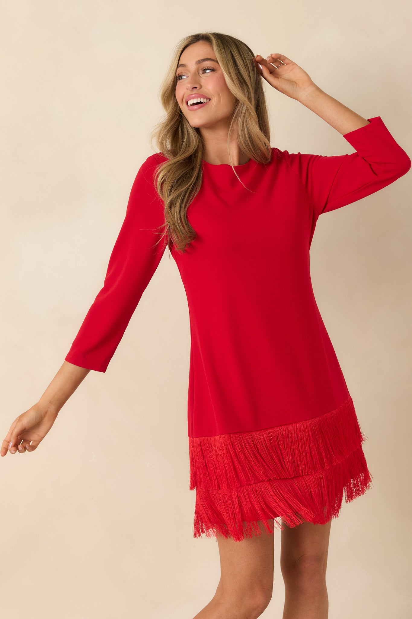 Cropped front detail showing the upper sleeve and subtle drape of the red woven fabric.