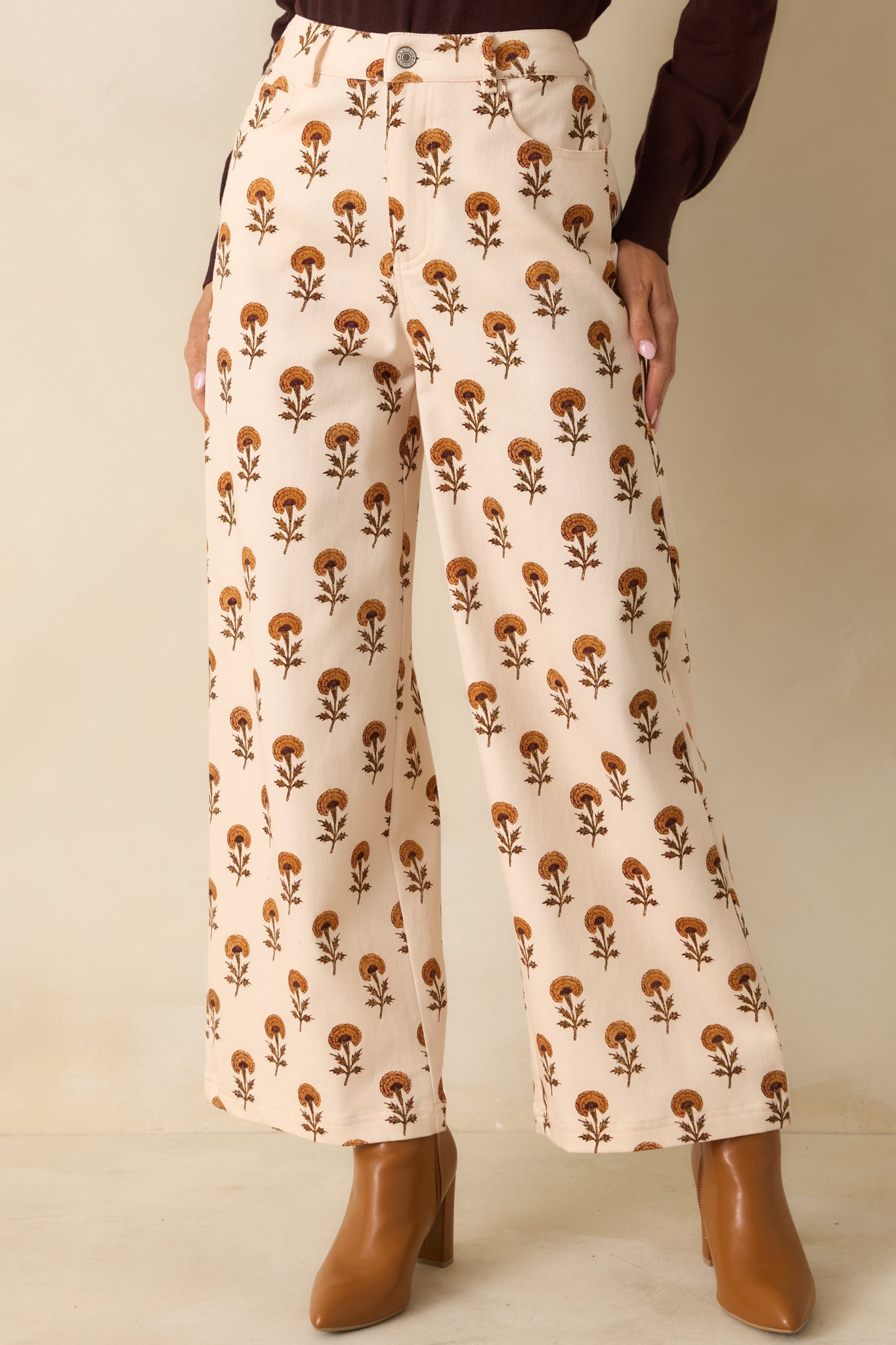 Cropped front view highlighting the flowing wide legs and marigold floral print.