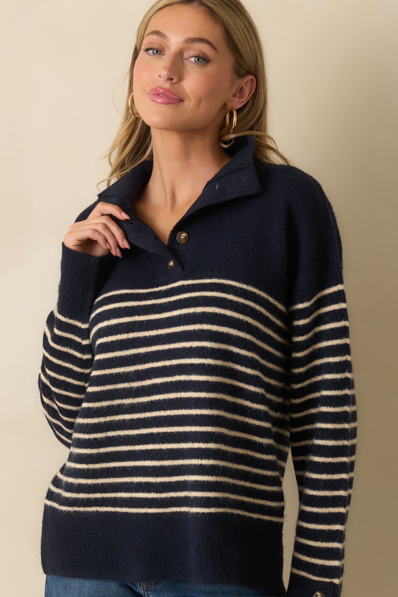 A cropped image highlighting the quarter button closure and ivory stripe pattern across the chest.