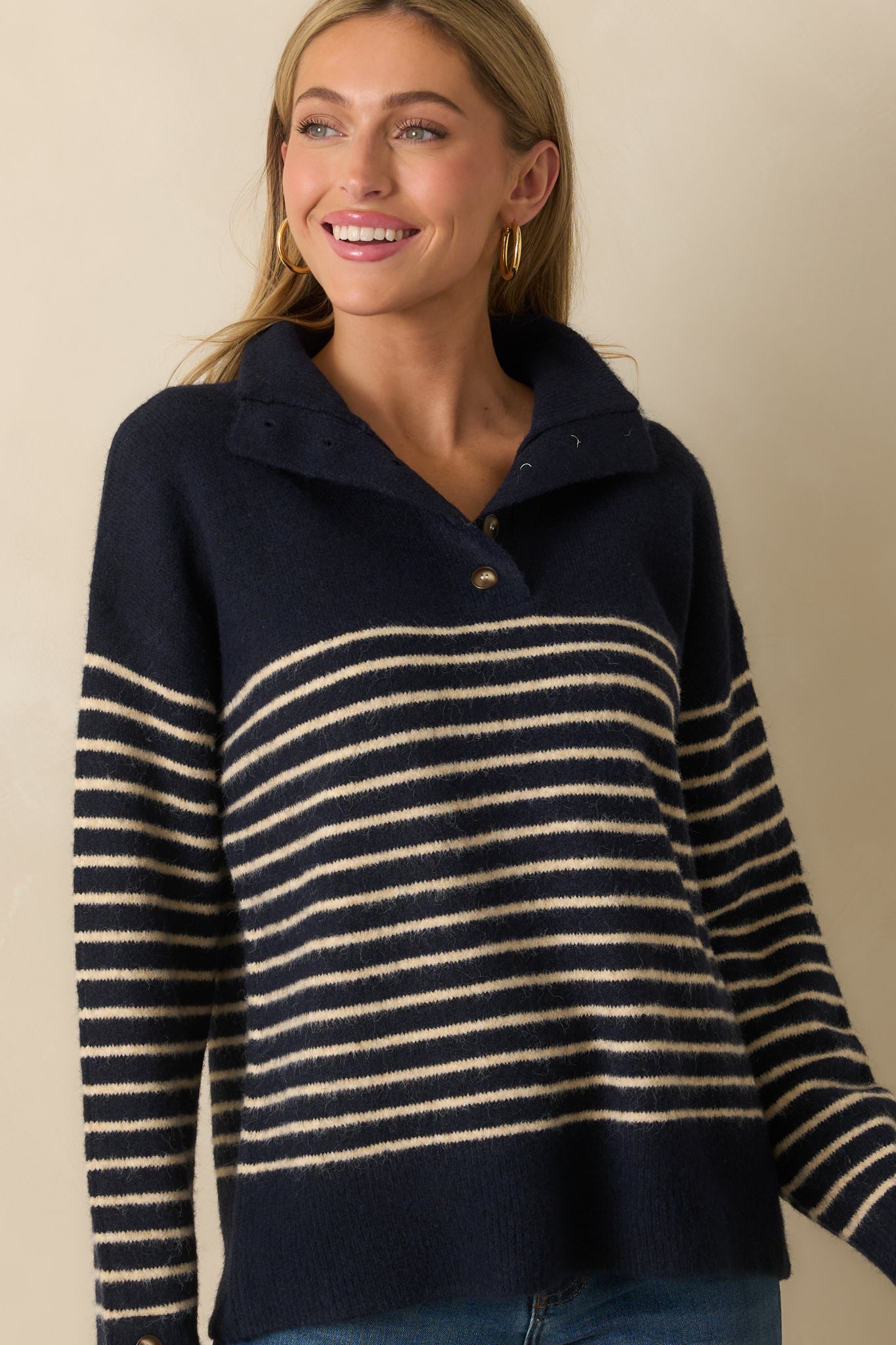 A cropped front view focusing on the fold-over collar and top portion of the striped sweater.