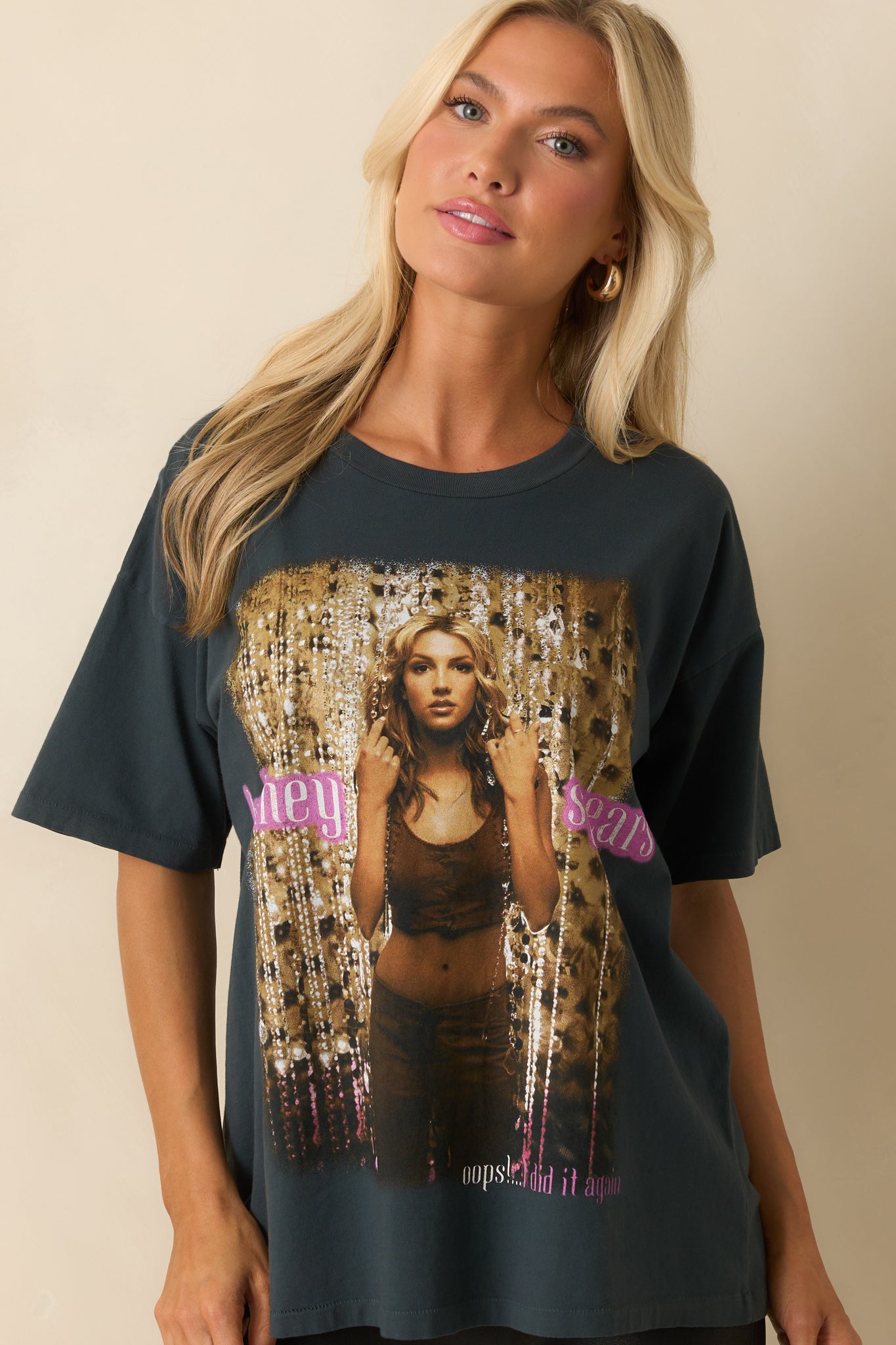 A cropped front view highlighting the short sleeves and graphic details across the chest.