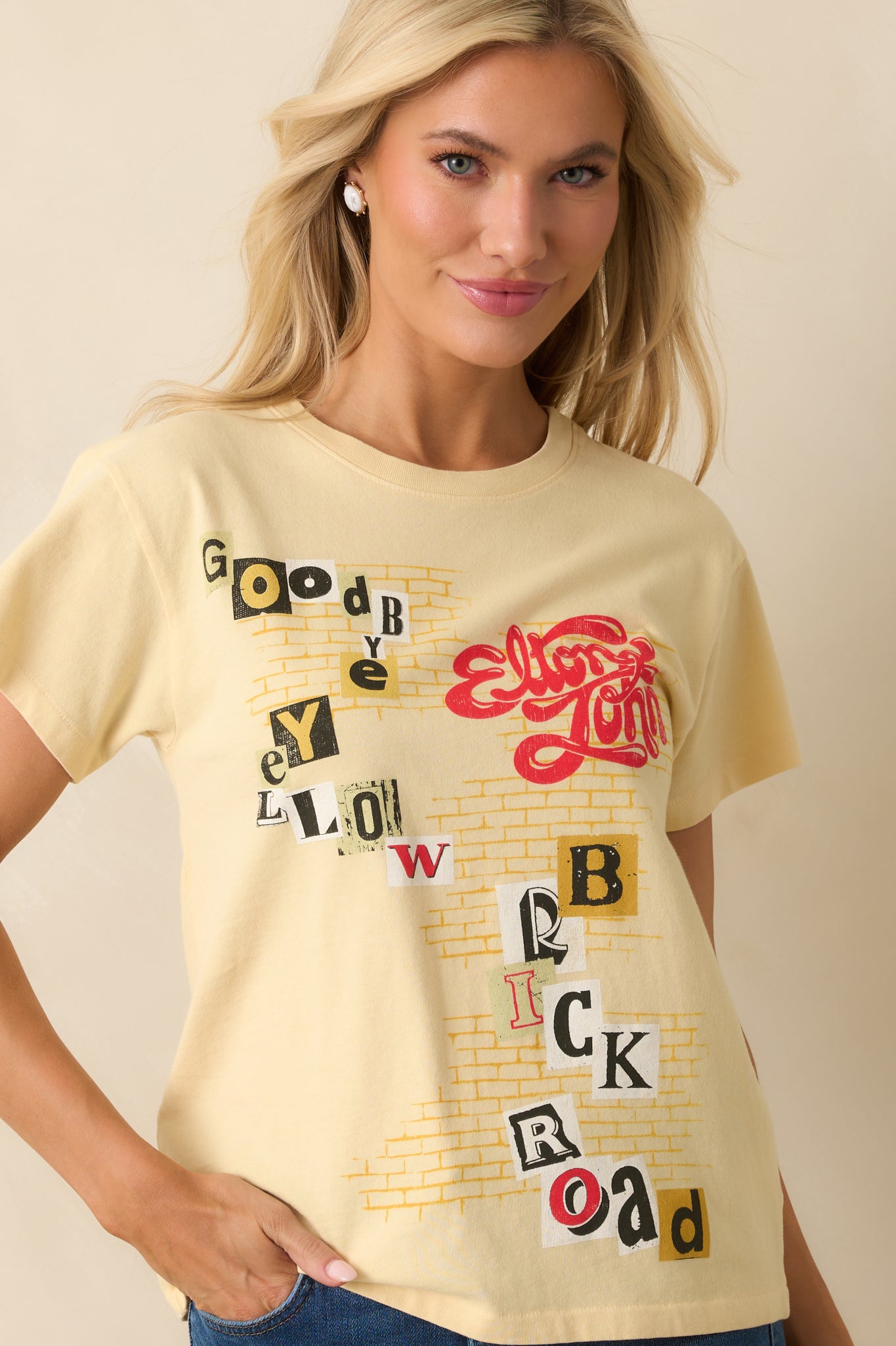 Cropped front view focusing on the brick road artwork and cut-and-paste lettering.