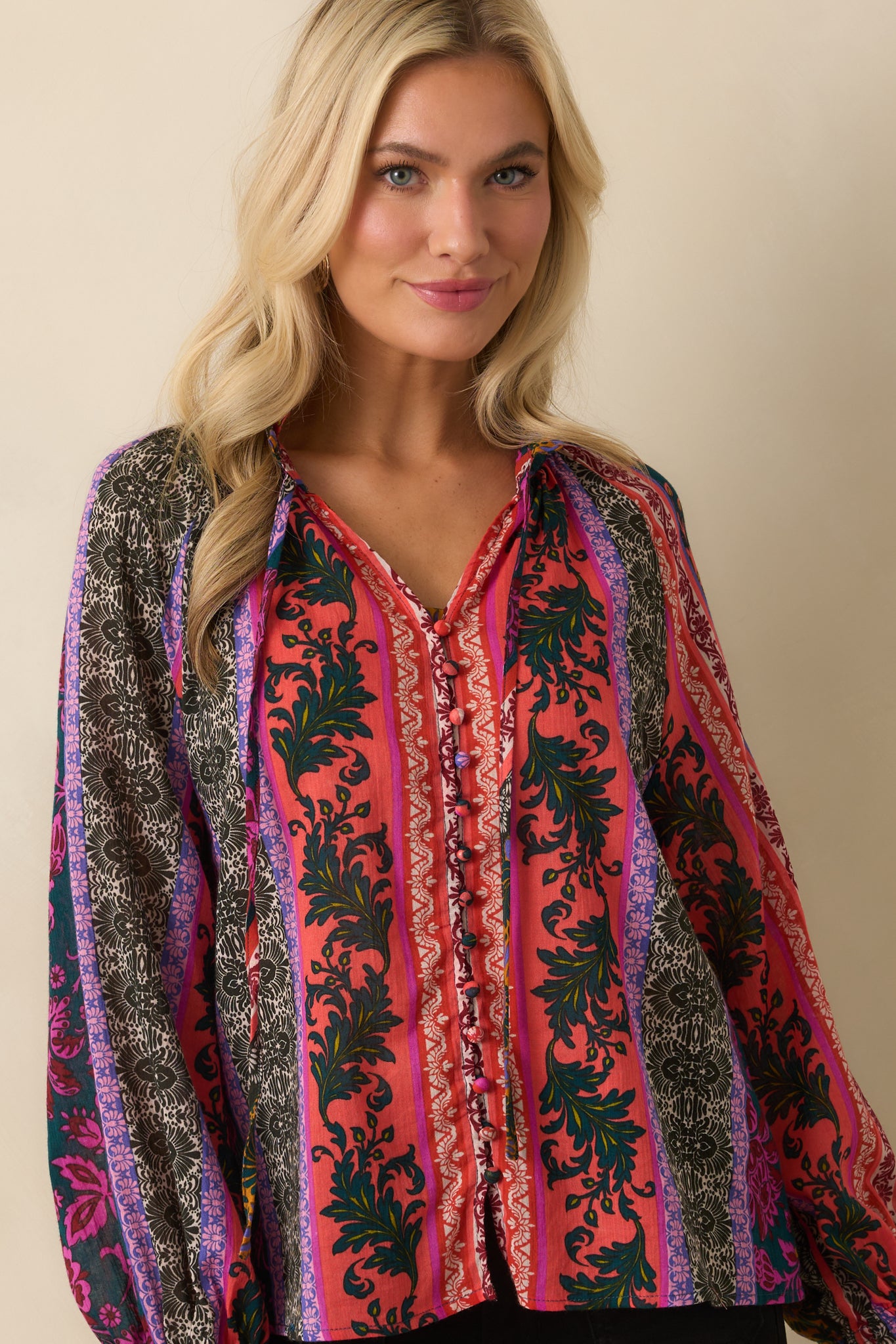 A cropped front view highlighting the button-front closure and ruffle trim accents.