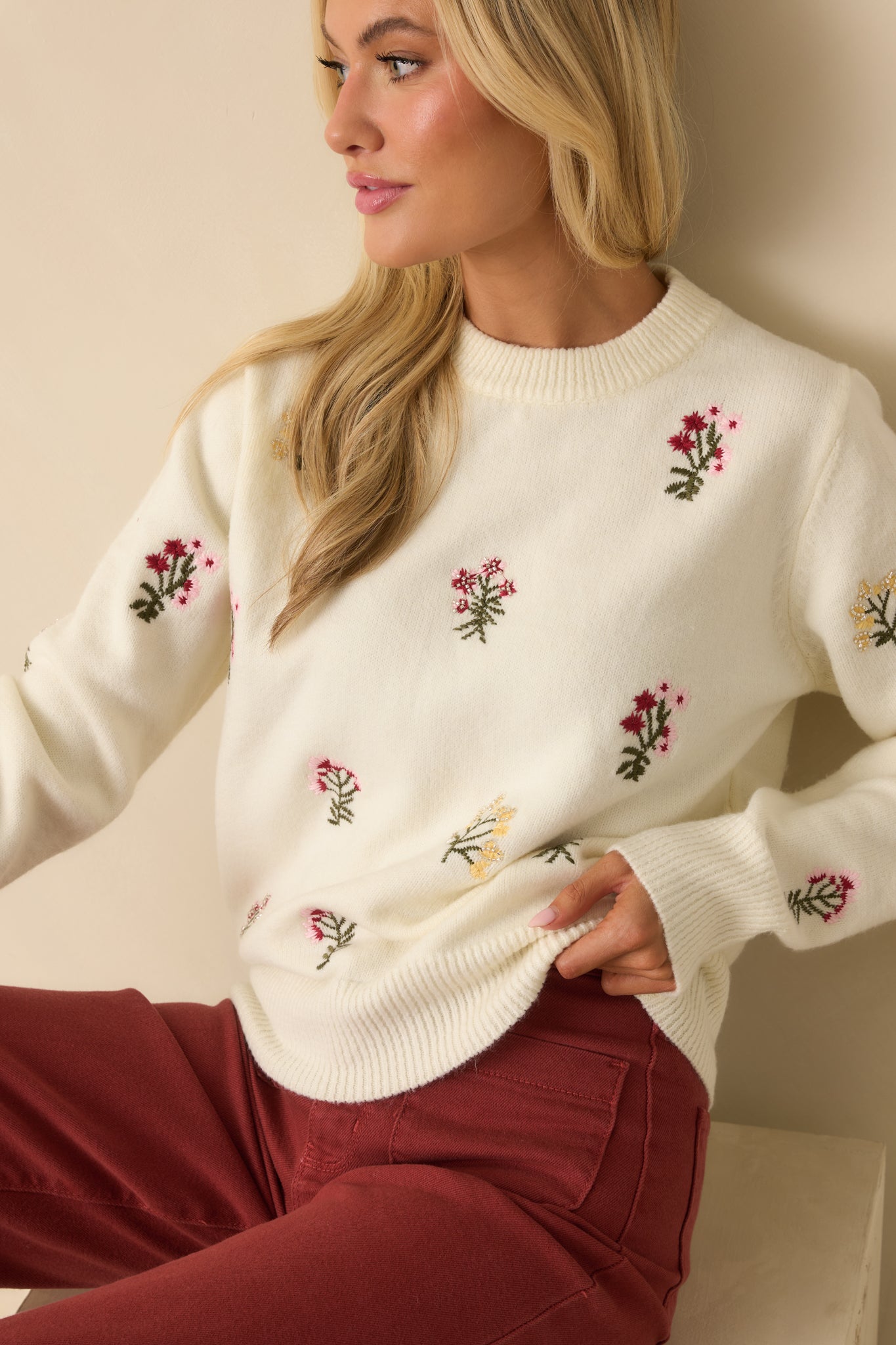 Cropped front view focusing on the crew neckline and floral embroidery details on the chest.