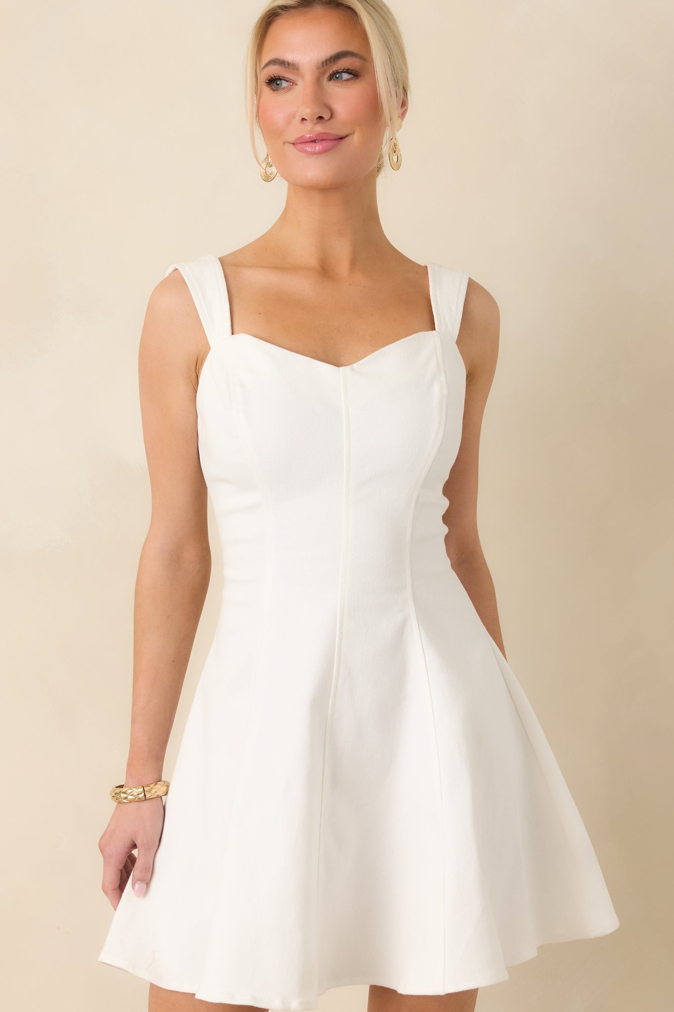Cropped front view showcasing the overall silhouette and structured paneling of the dress.