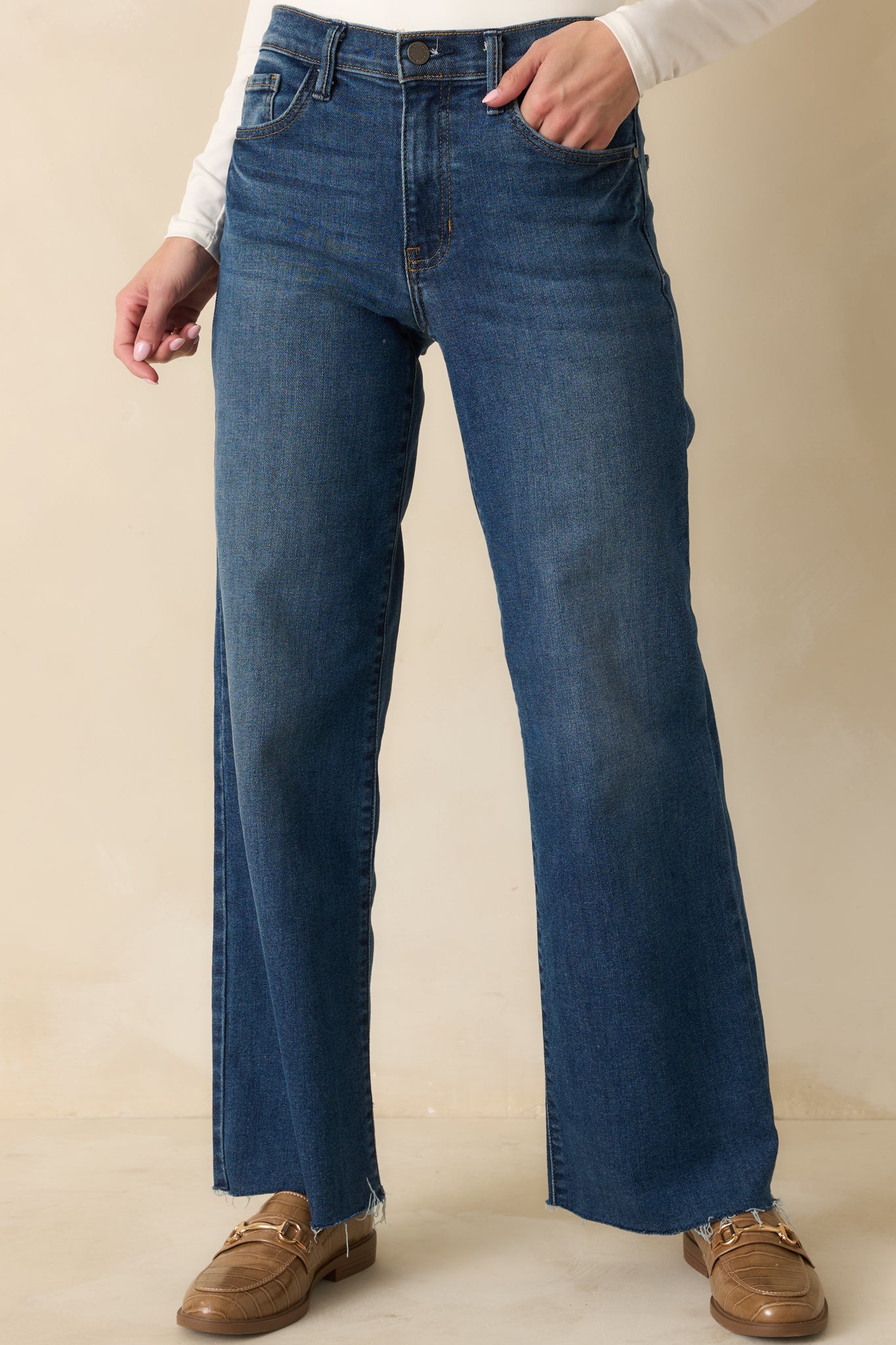 Cropped front view emphasizing the button zipper closure and belt loops.