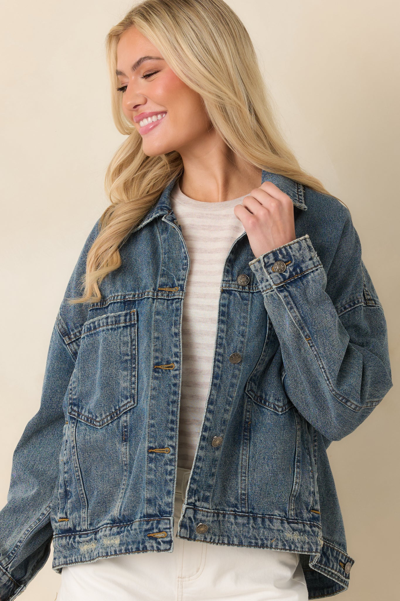 Cropped front view focusing on the button-front detail and structured collar of the denim jacket.