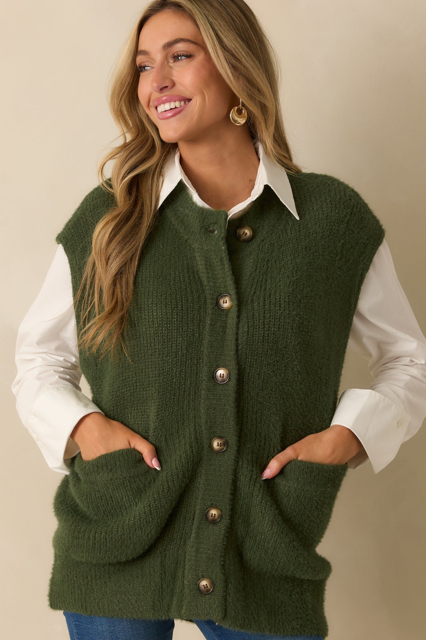 Cropped front view showing the texture and softness of the green knit fabric.