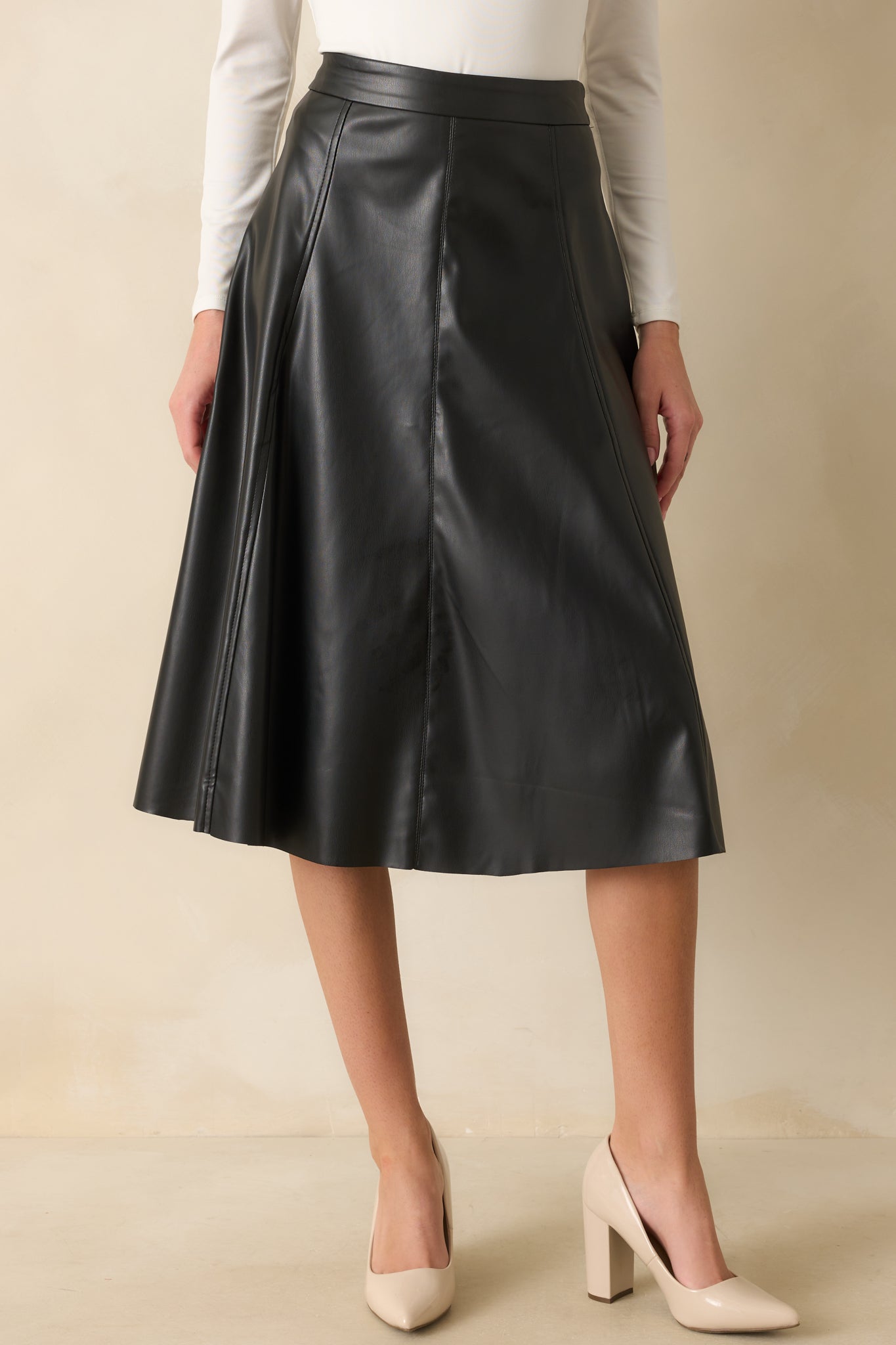 A cropped front shot focusing on the waist and stitched seams of the skirt.