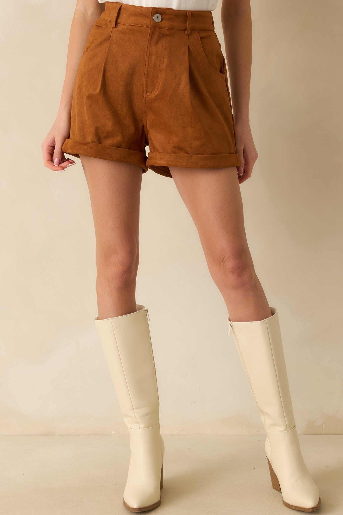 Cropped front view focusing on the pleated detailing and smooth faux suede texture.