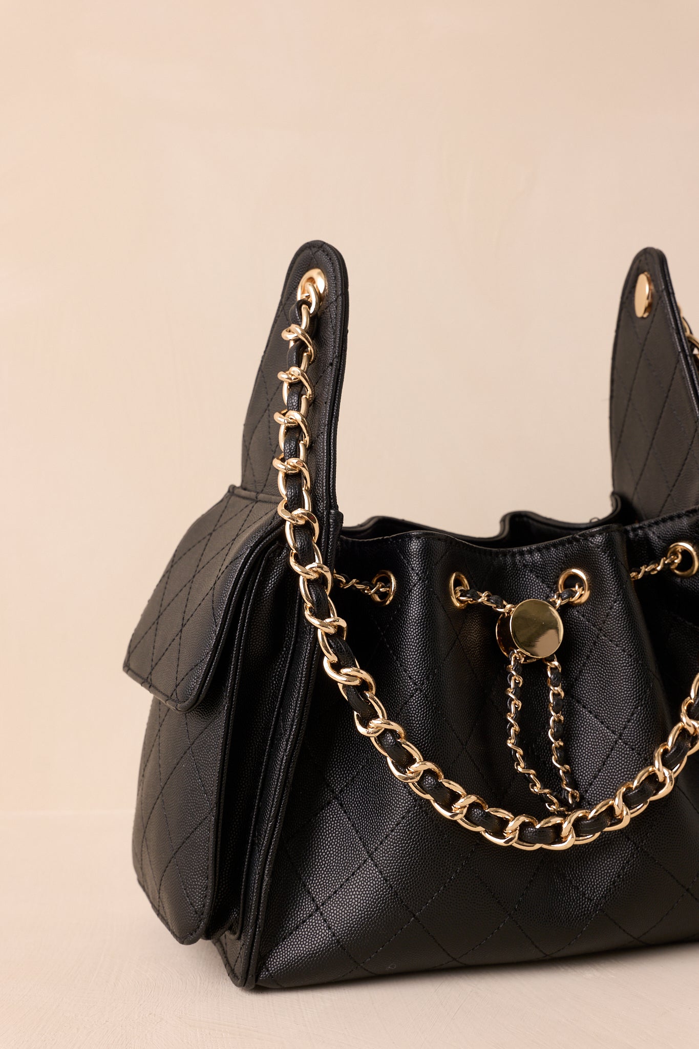 Cropped front view emphasizing the woven drawstring threaded through gold grommets.