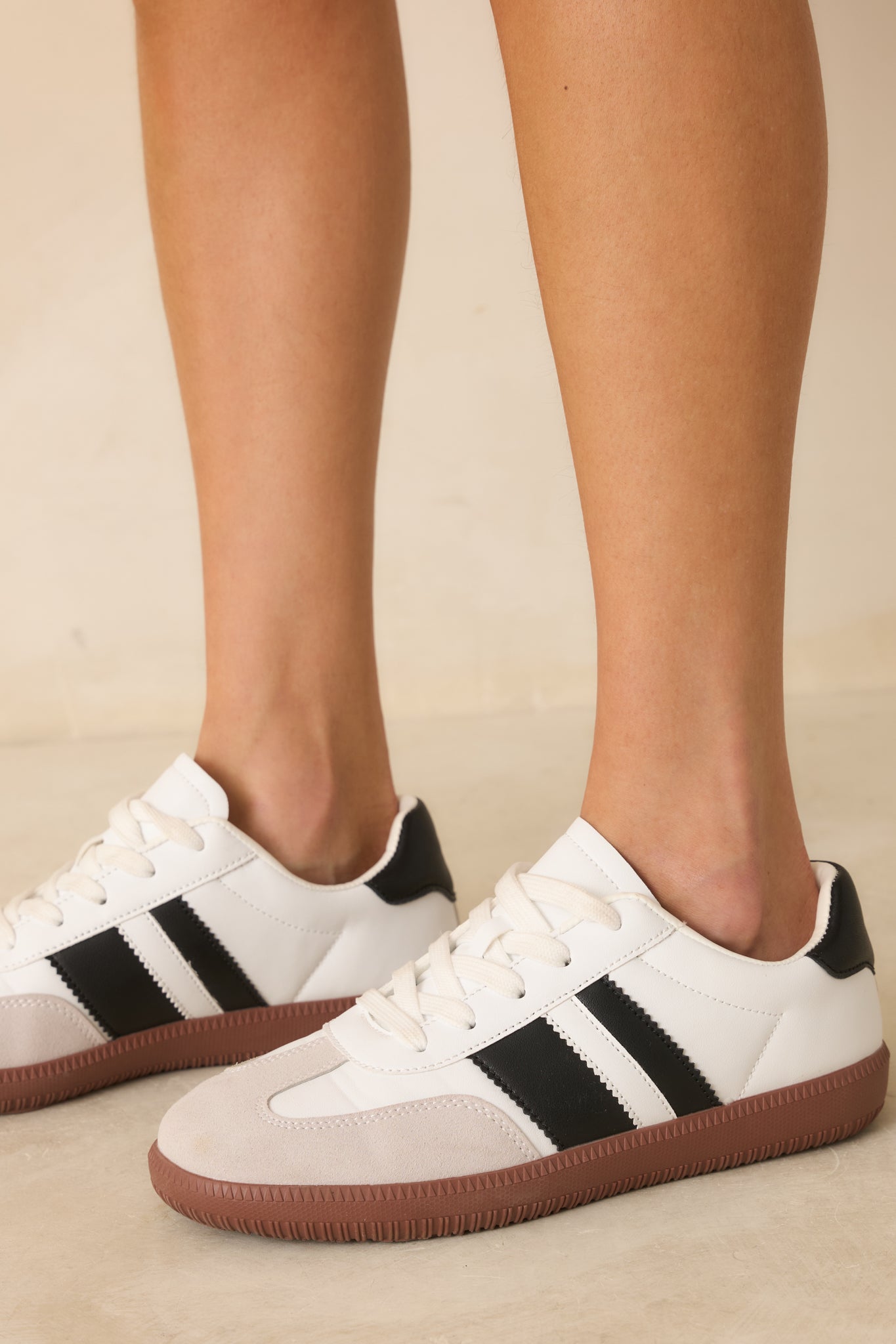 Cropped detail focusing on the gum rubber sole and stitching along the lower edge of the sneaker.