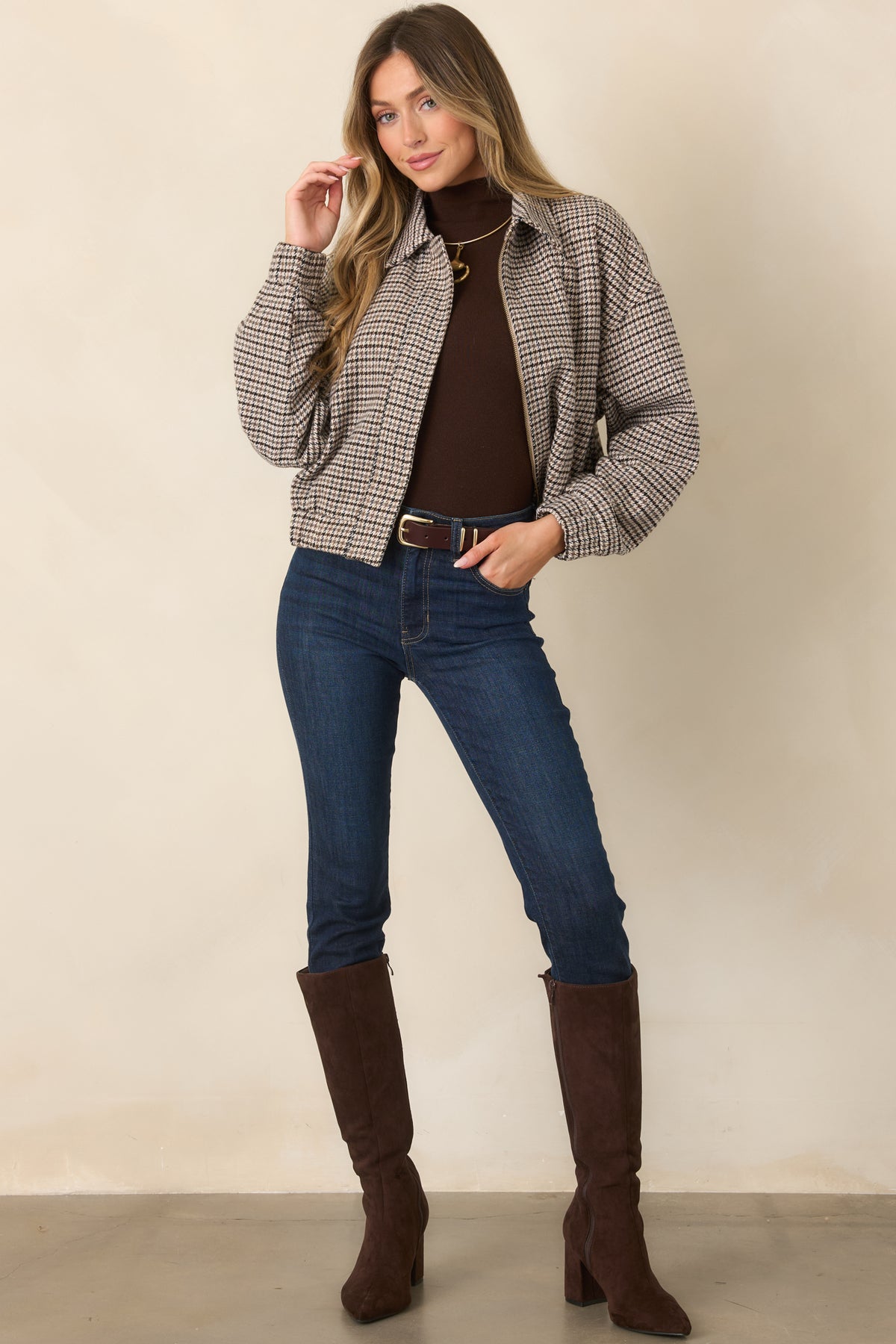 A cropped hem and roomy silhouette create an easy layering shape on this houndstooth zip-front jacket.