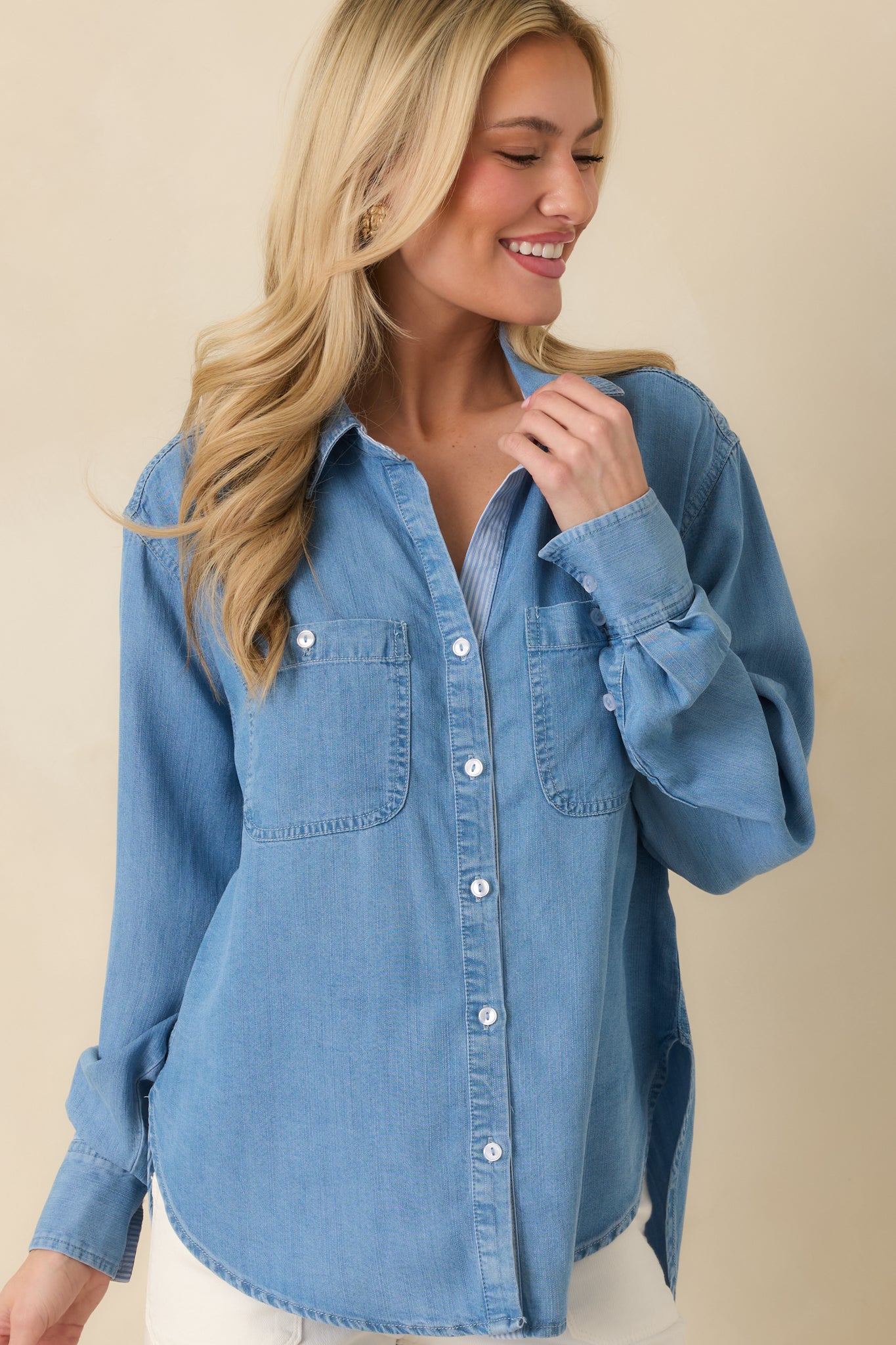 Cropped image focusing on lightweight denim fabric and utility-inspired design details of the shirt.