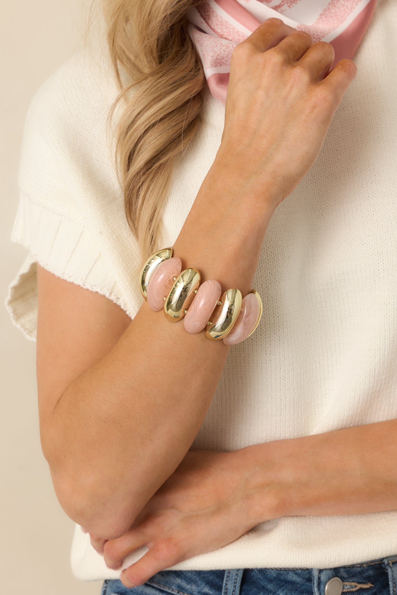 Cropped image showcasing the faux rose quartz–inspired pink beads contrasted with polished gold beads.
