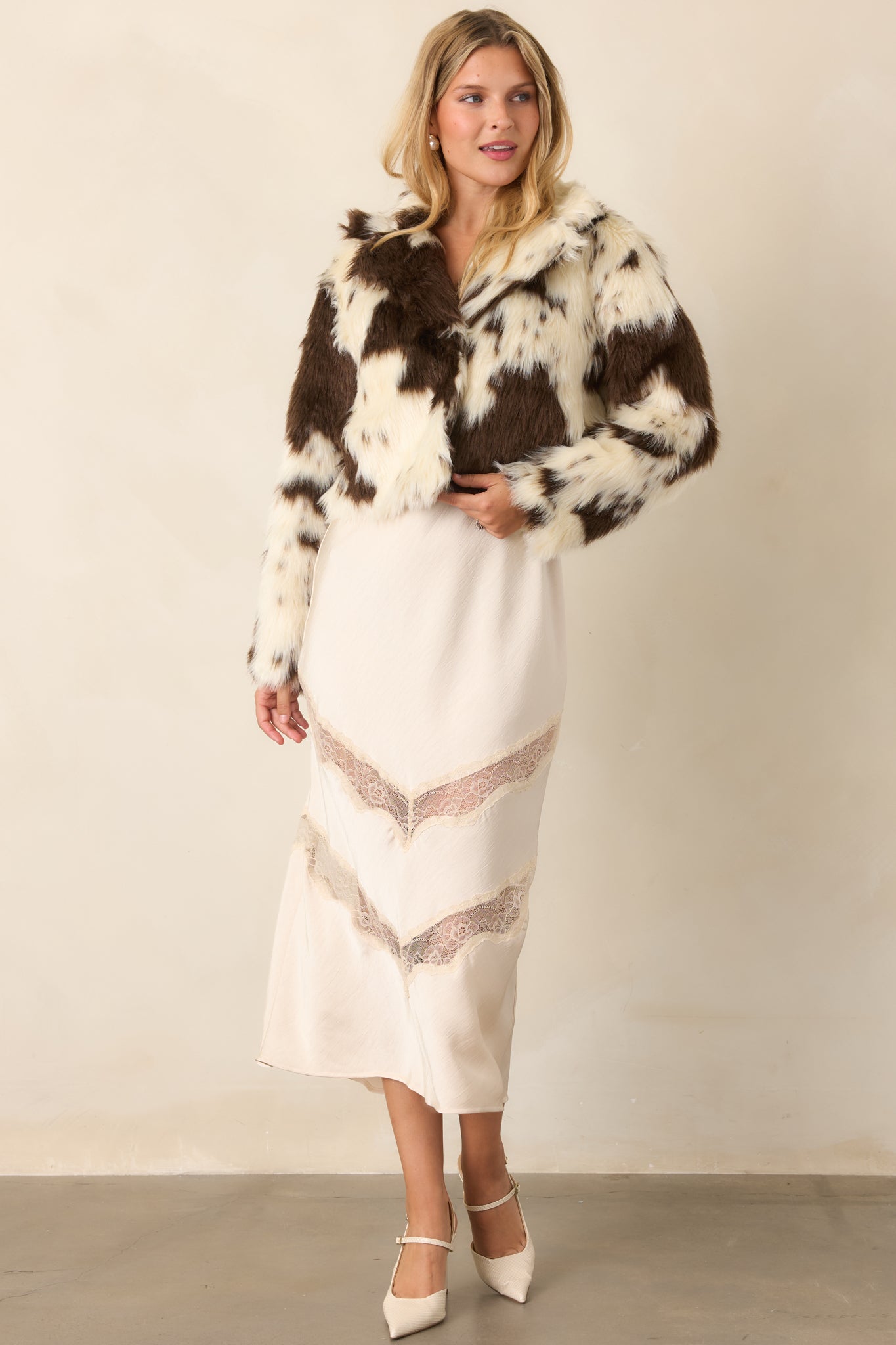 Cropped jacket with a relaxed bomber silhouette, wide collar, long sleeves, and smooth lined interior.